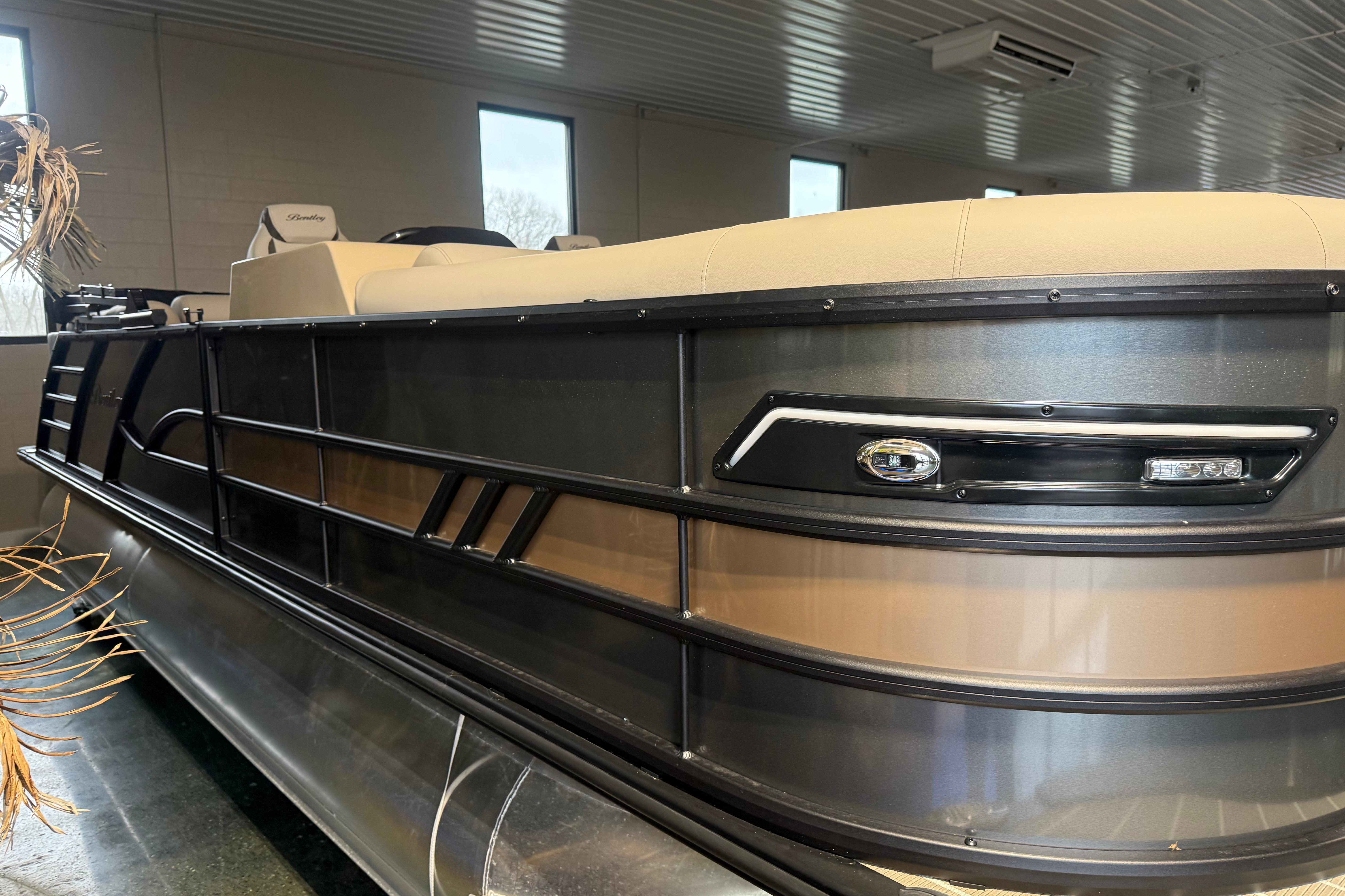 2026 Bentley Pontoons Elite 223 Admiral pontoon boat in showroom, side view.