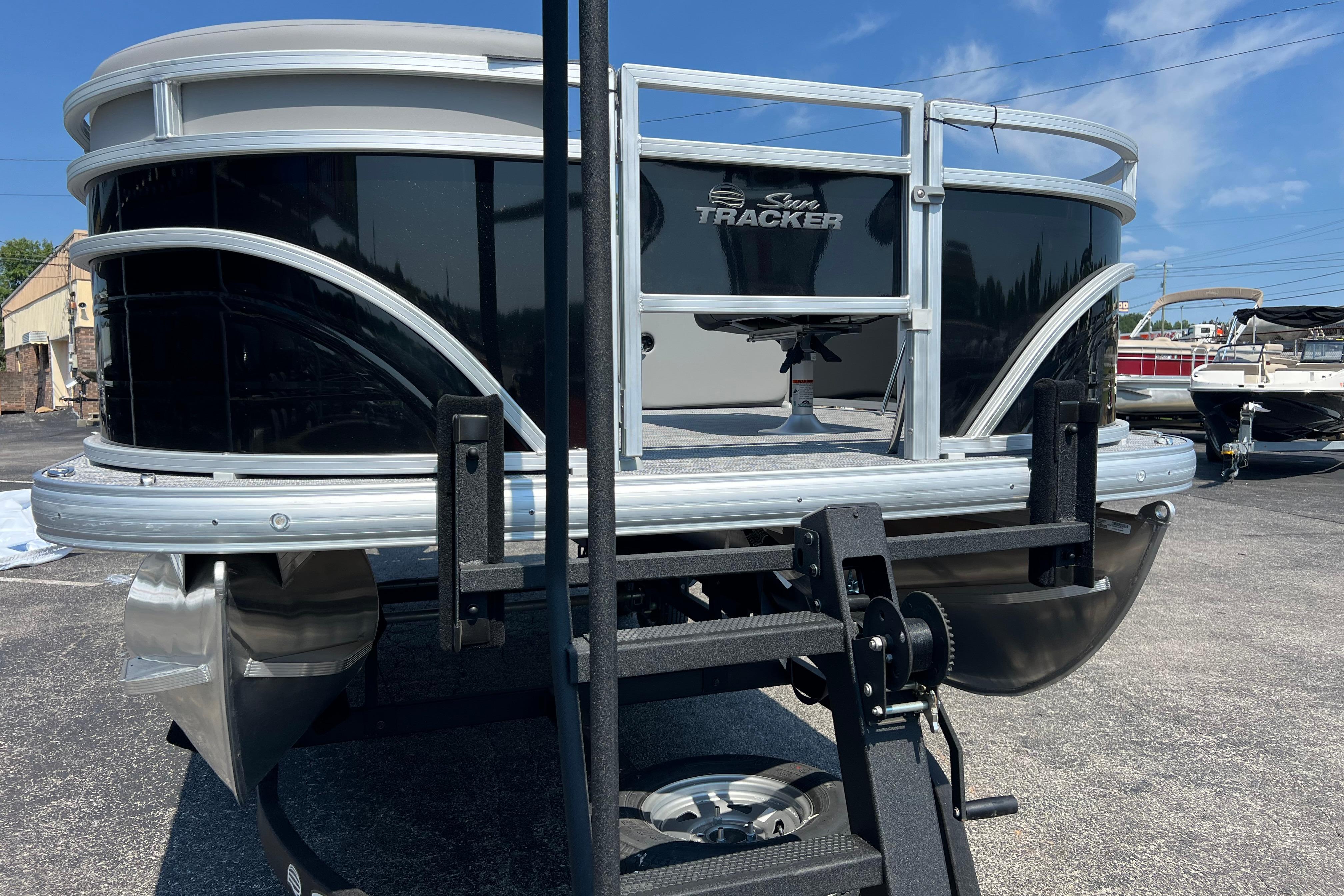 2026 Sun Tracker SportFish 20 DLX pontoon boat on trailer, black exterior.