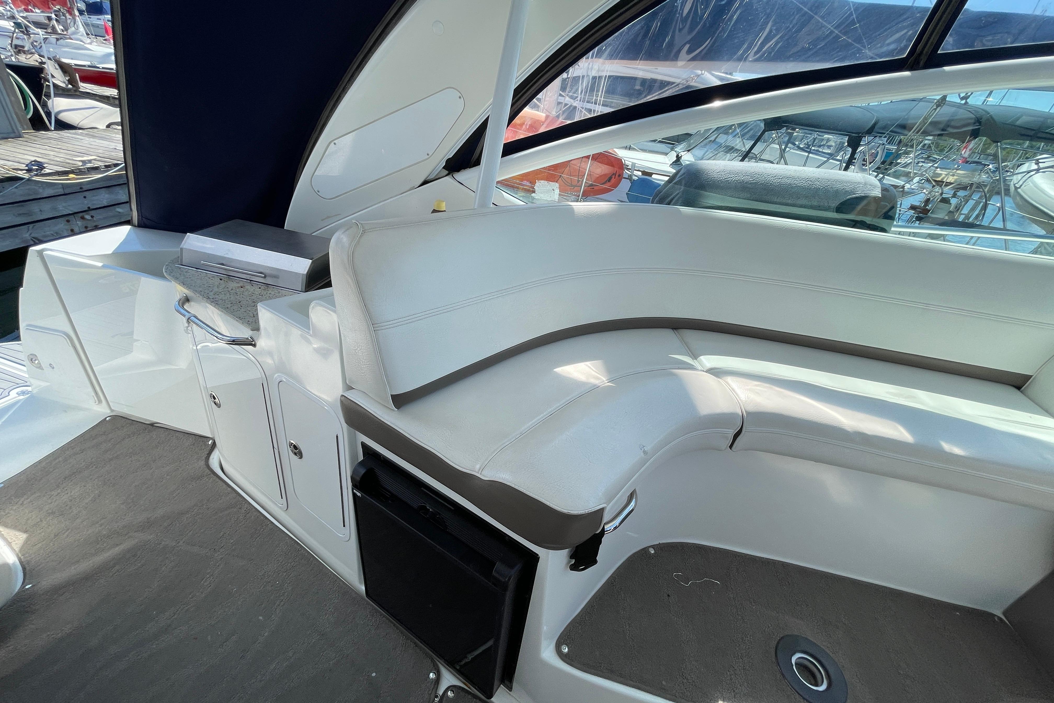 Interior of 2011 Cruisers Yachts 360 Express with white seating and kitchenette.