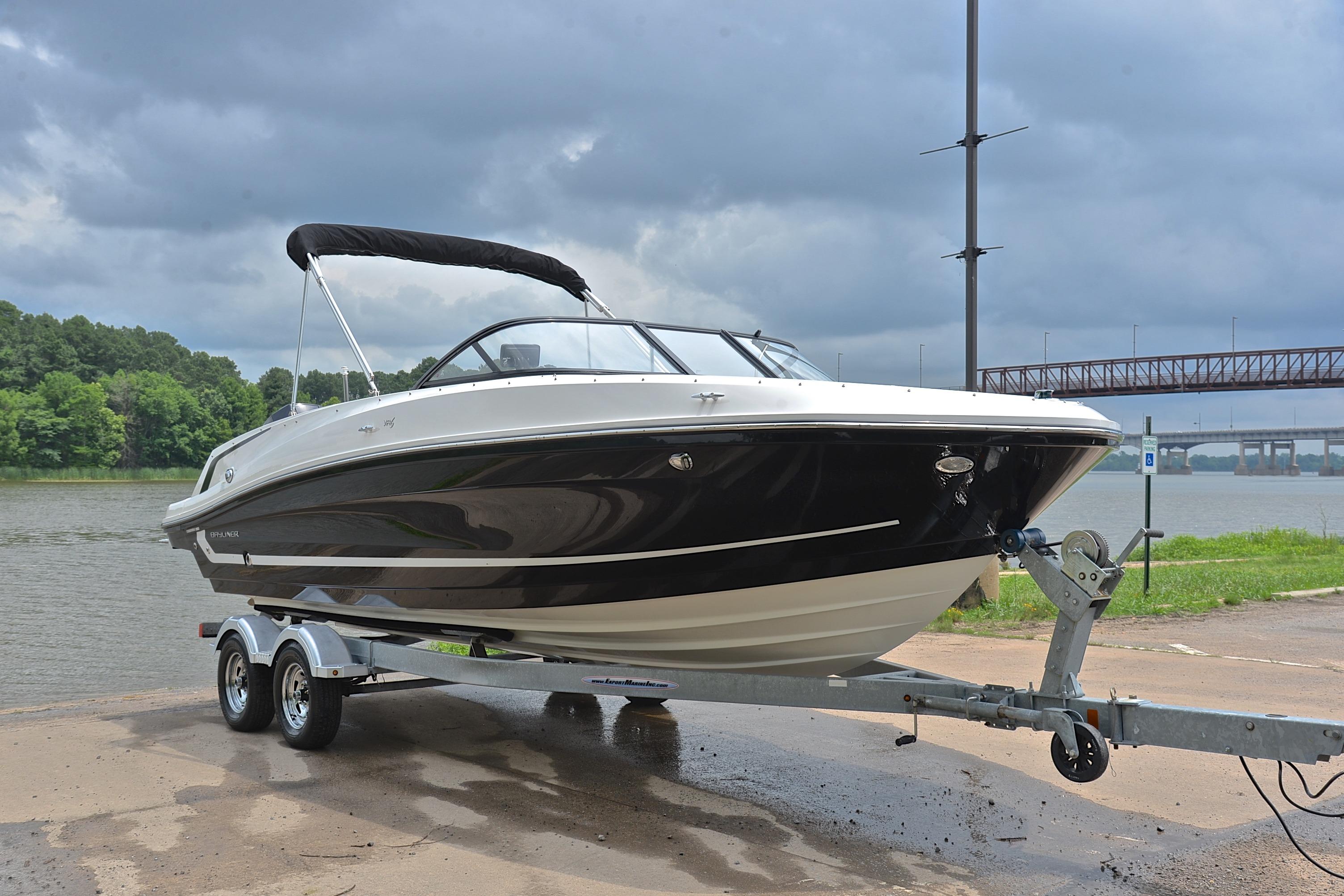 2019 Bayliner VR6 Bowrider OB on trailer by a river under cloudy skies.