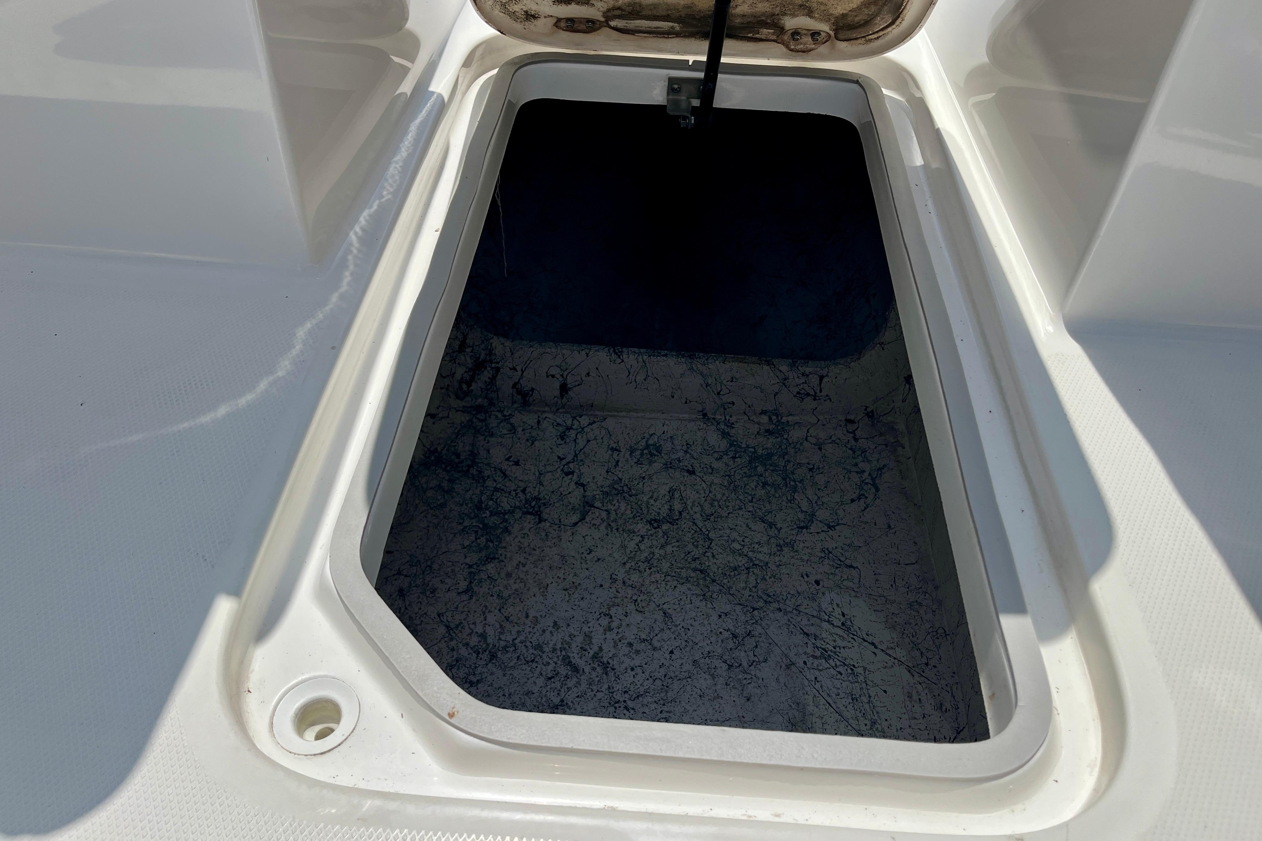 Open storage compartment on 2024 Hurricane Sundeck Sport 218 OB boat.