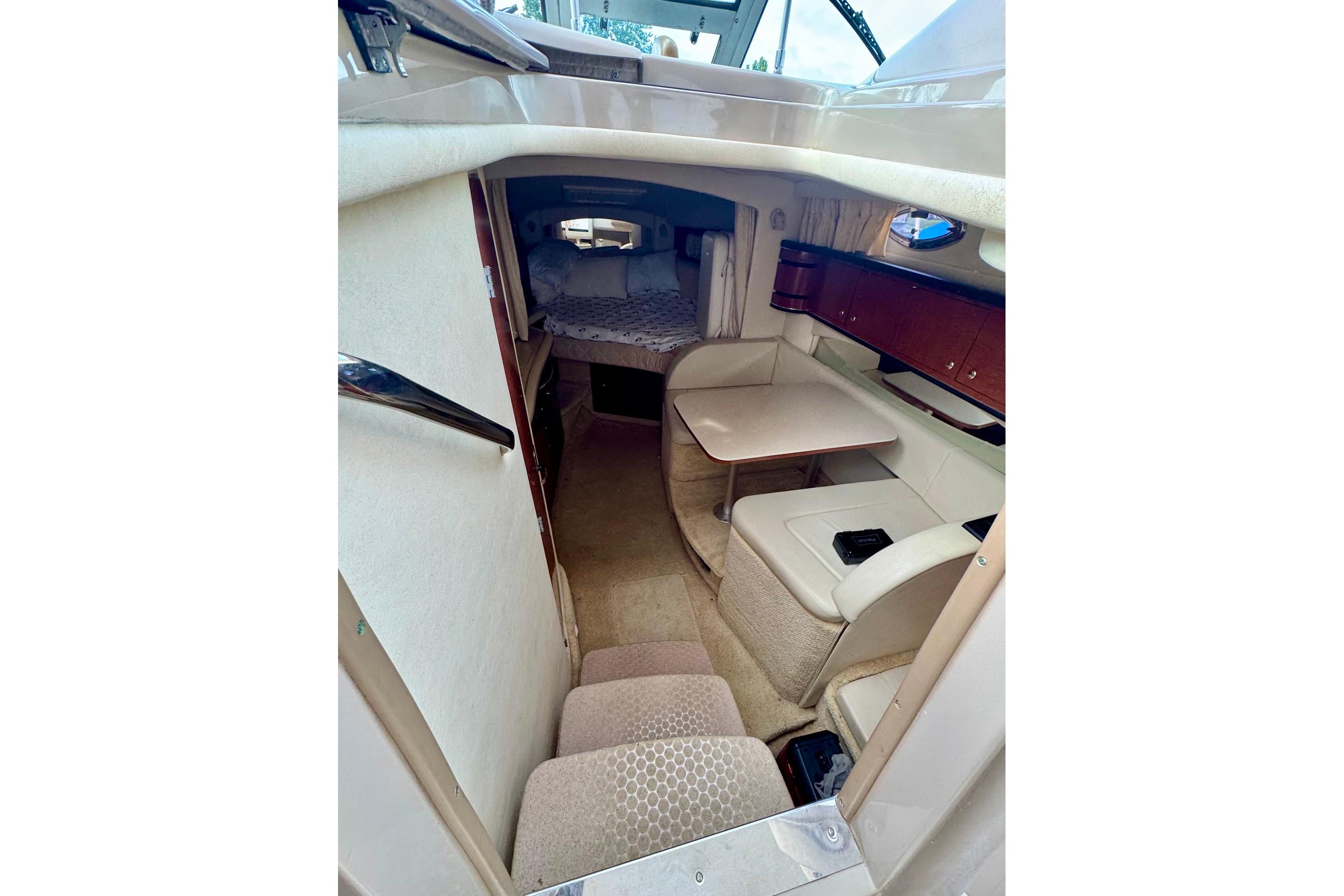 Interior view of 2003 Sea Ray 300 Sundancer cabin with seating and sleeping area.