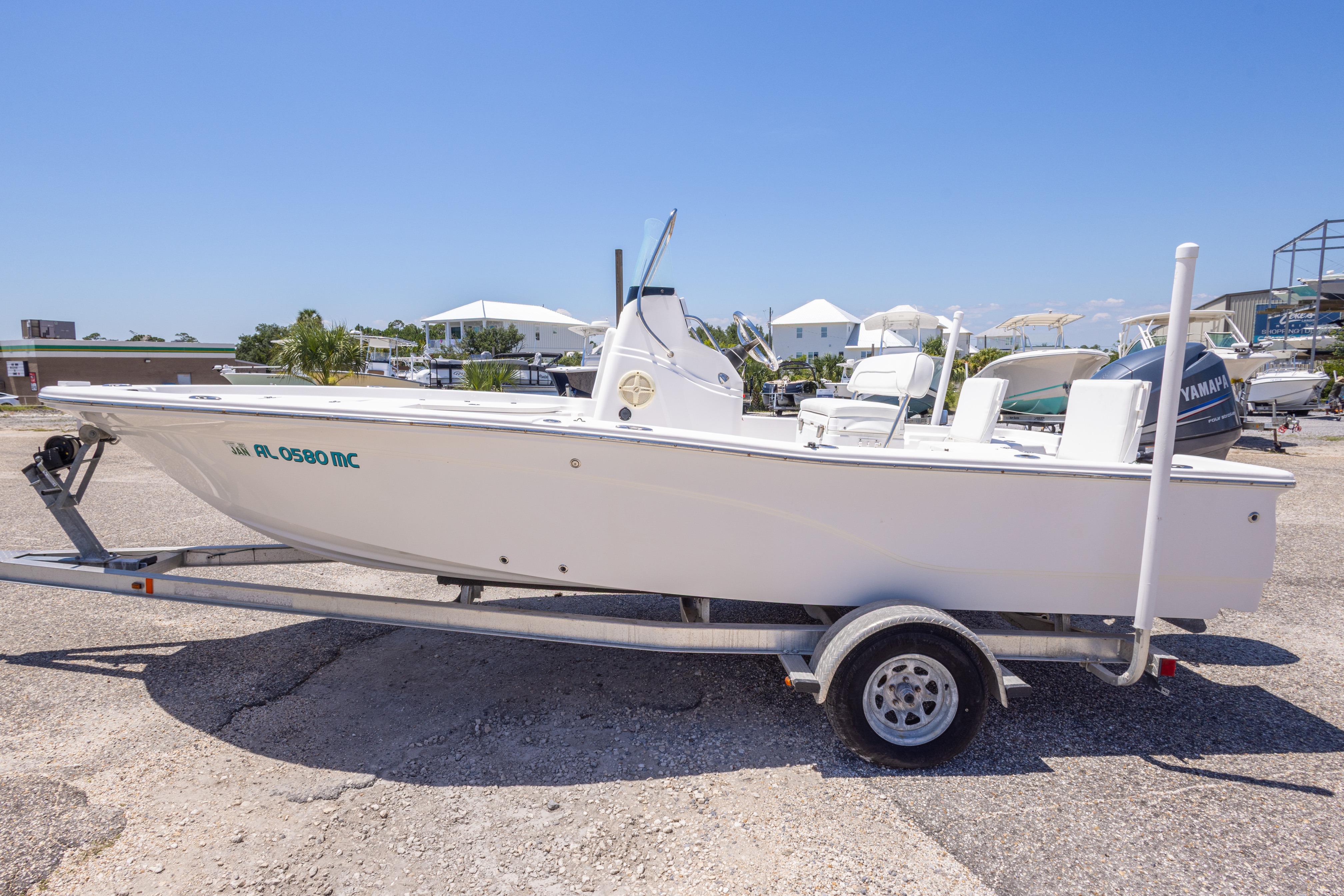 2011 Sea Fox 200XT boat on trailer in sunny marina setting.