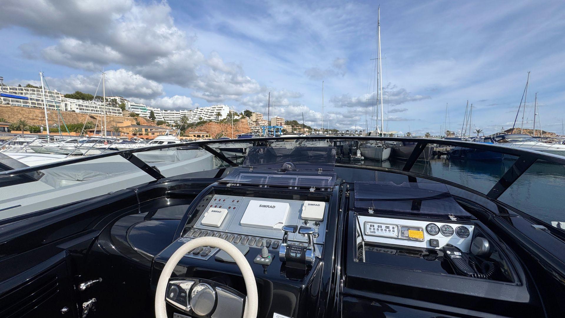 Cockpit view of 2012 Riva Rivarama Super 44 yacht docked in a marina.