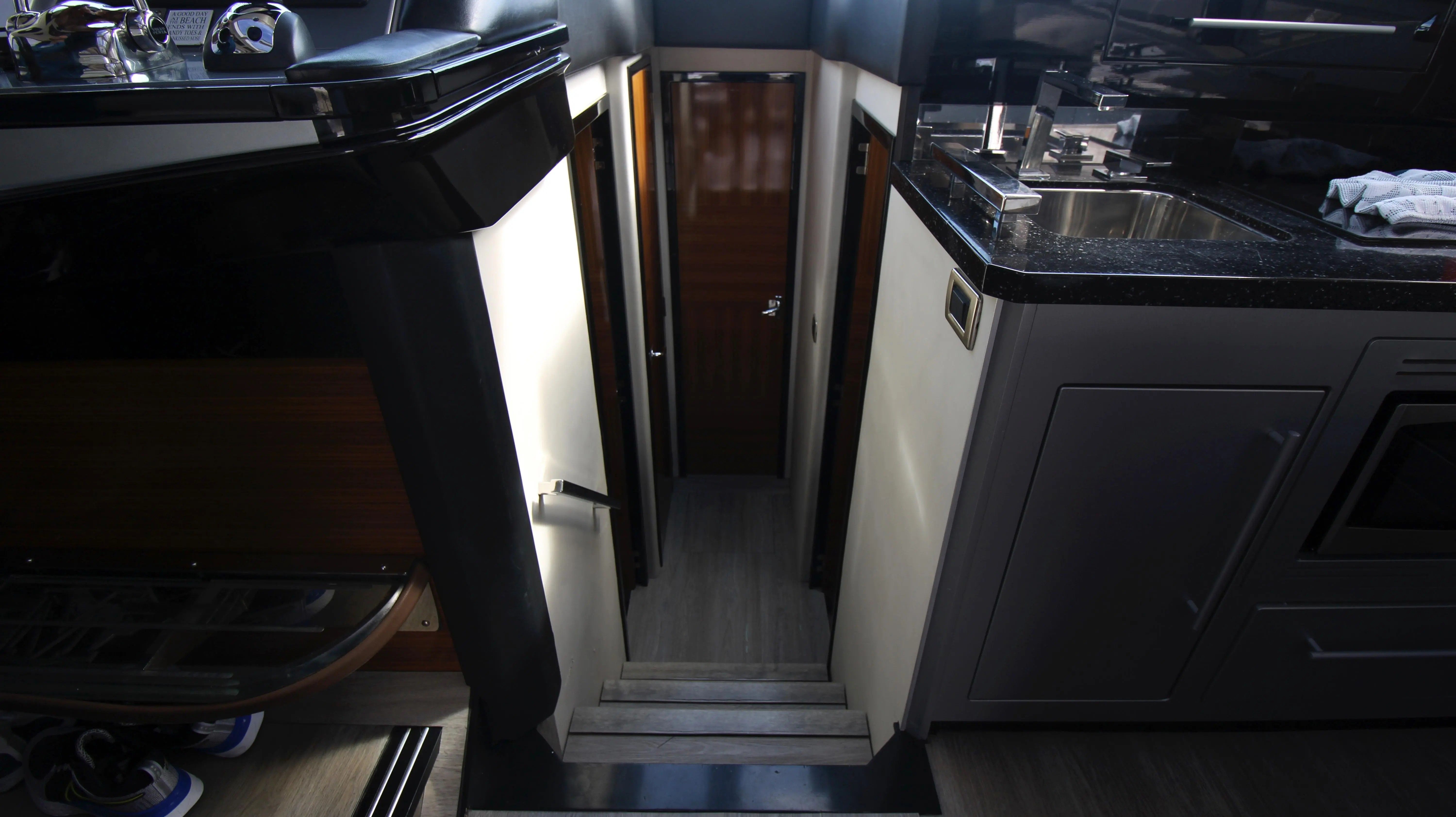 Interior of a 2010 Marquis Sport Coupe with stairs and kitchen area.
