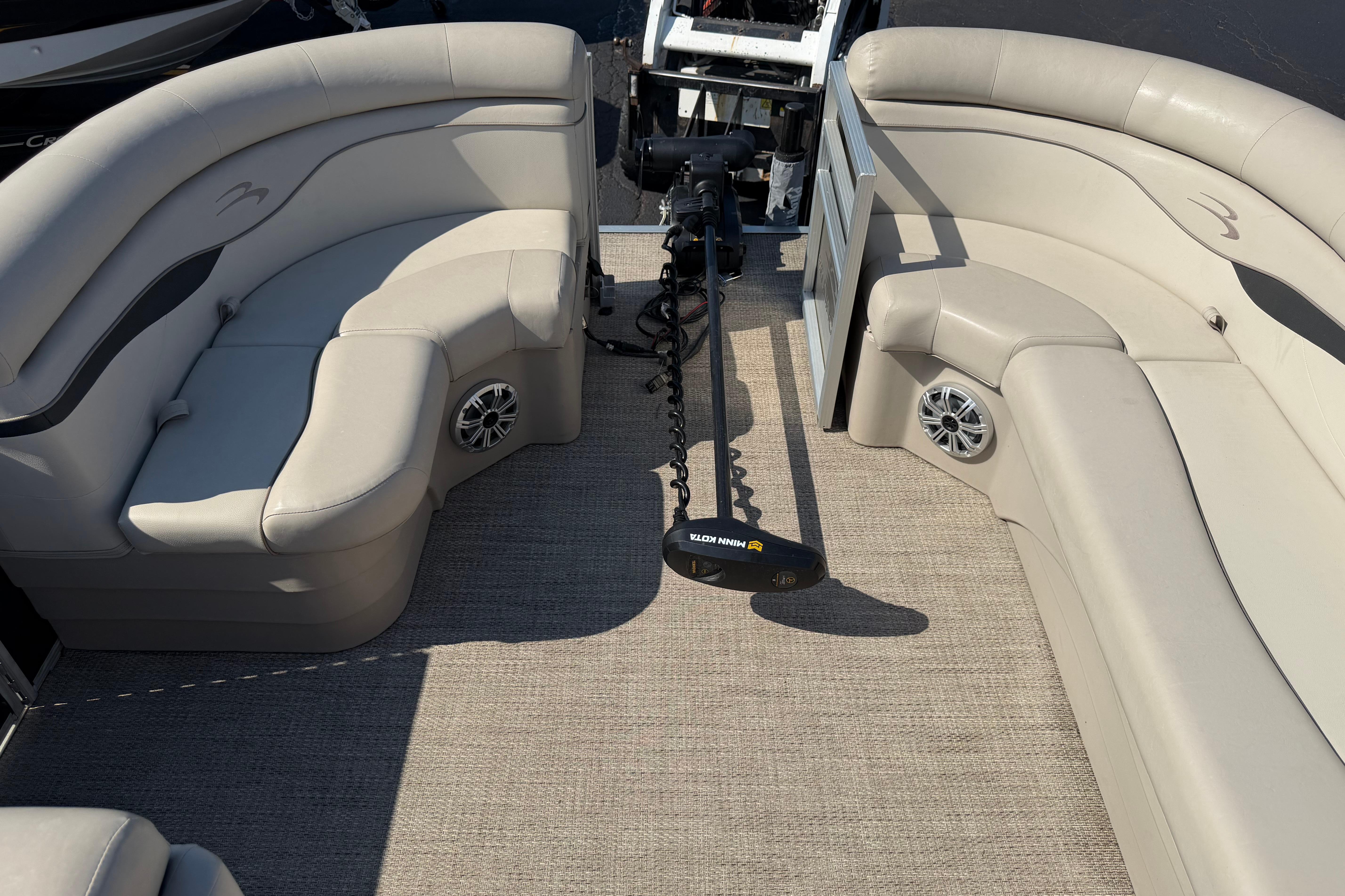 2018 Bennington 21 SF boat interior with beige seating and Minn Kota trolling motor.