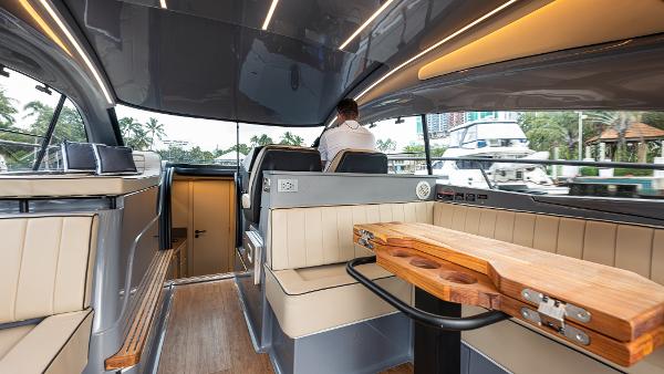 Luxurious interior of 2025 Hanover 415 yacht with modern seating and wooden table.