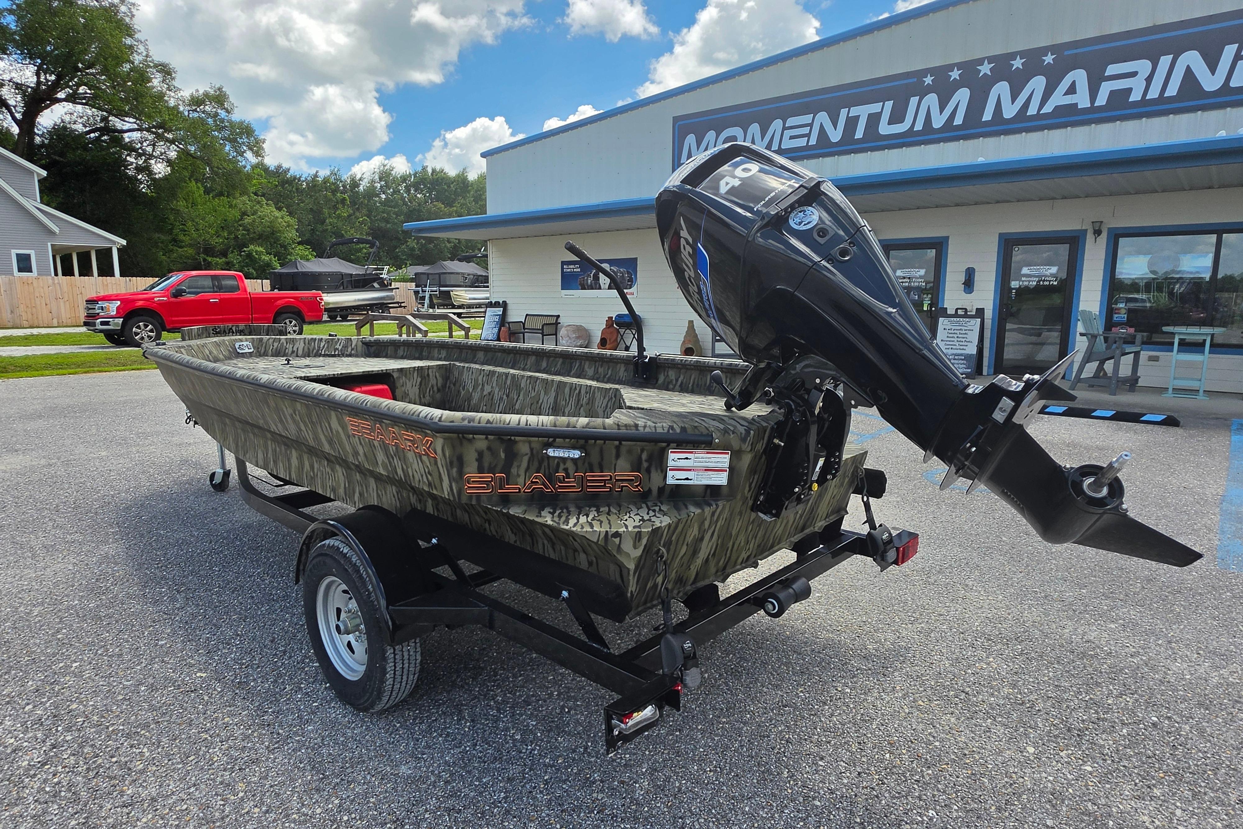 2025 SeaArk 1752 Slayer boat with motor, parked outside Momentum Marine dealership.