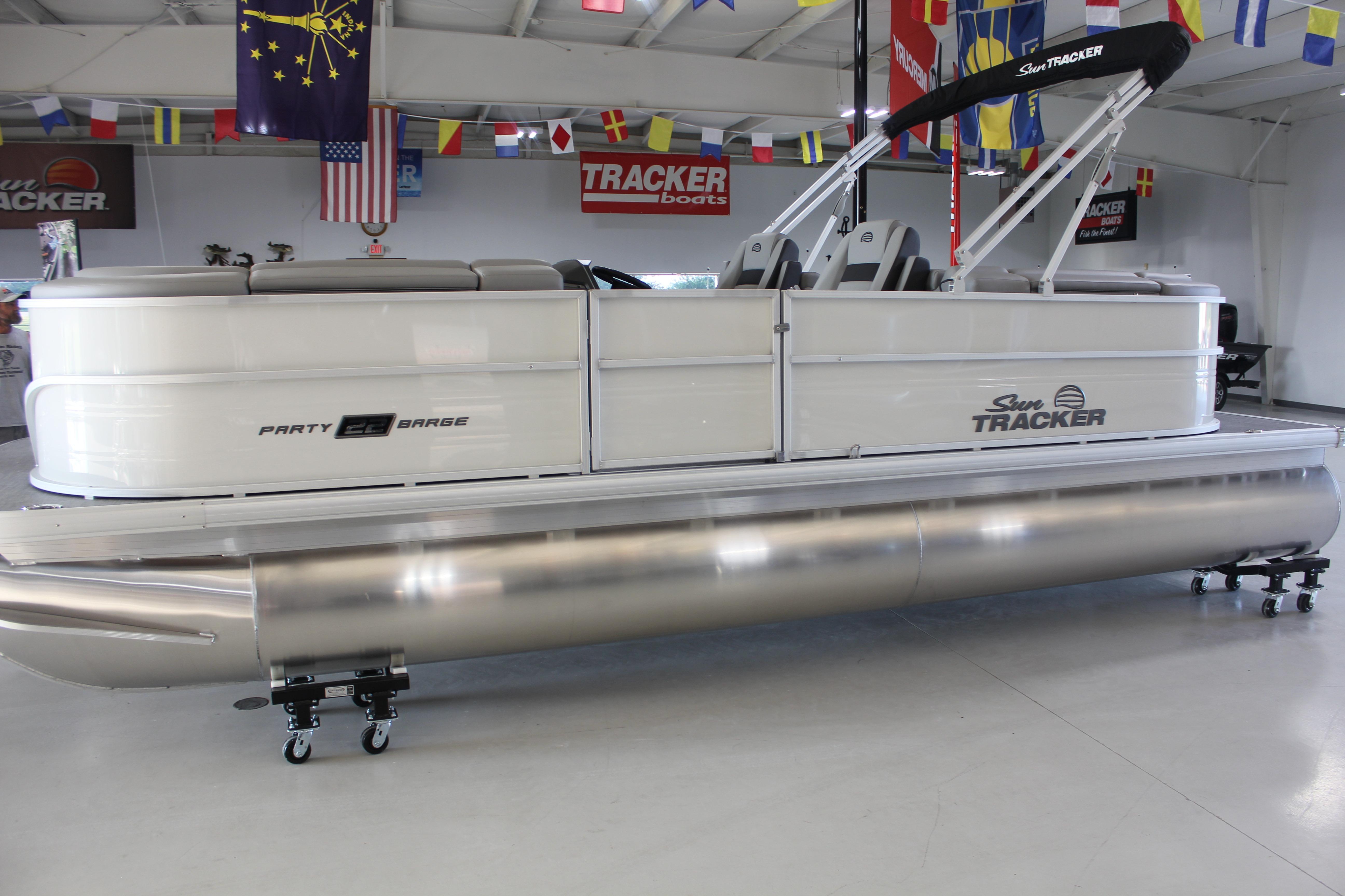 2026 Sun Tracker Party Barge 22 DLX pontoon boat in showroom setting.