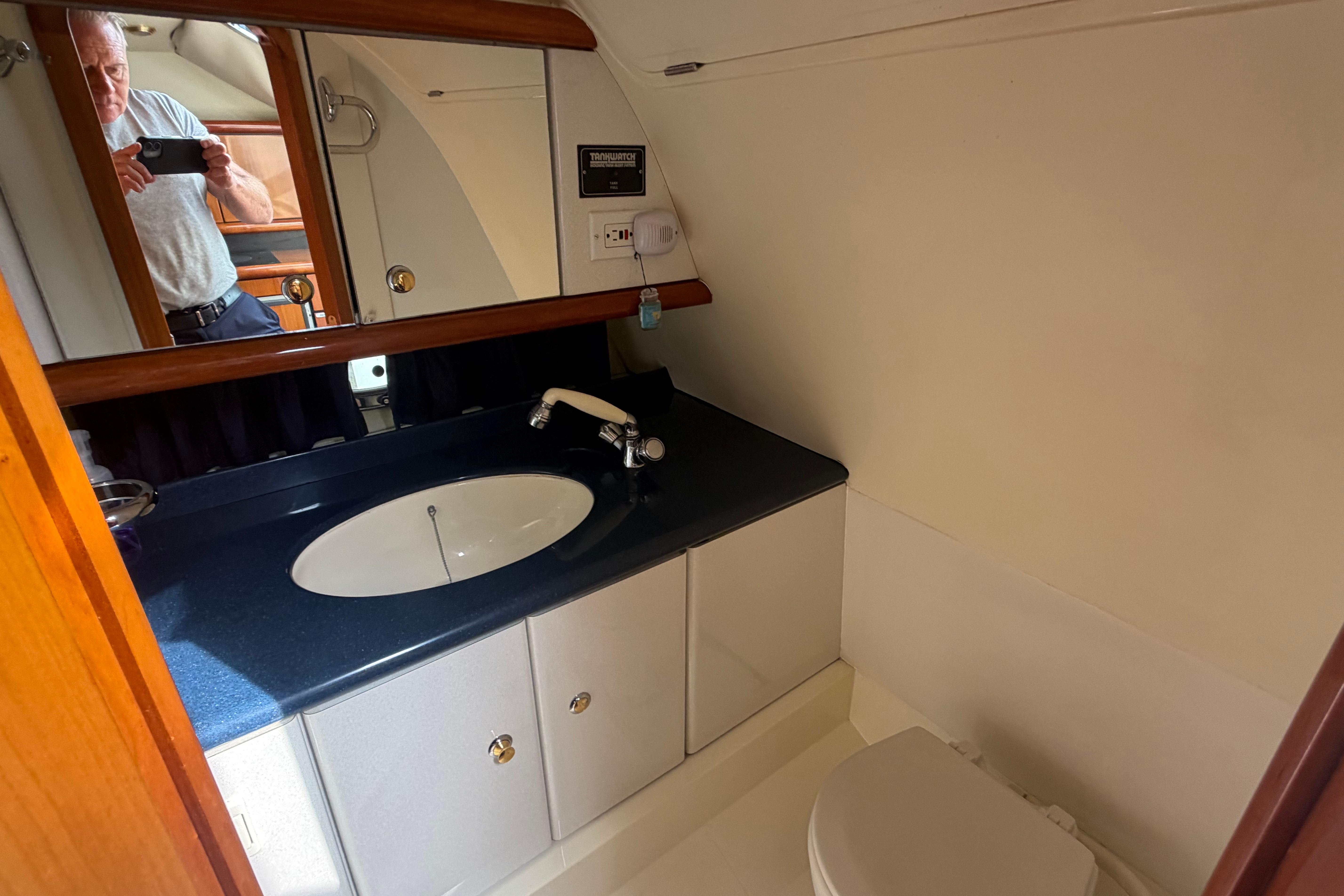 Bathroom interior of 2000 Sunseeker Superhawk 34 yacht with sink and mirror.