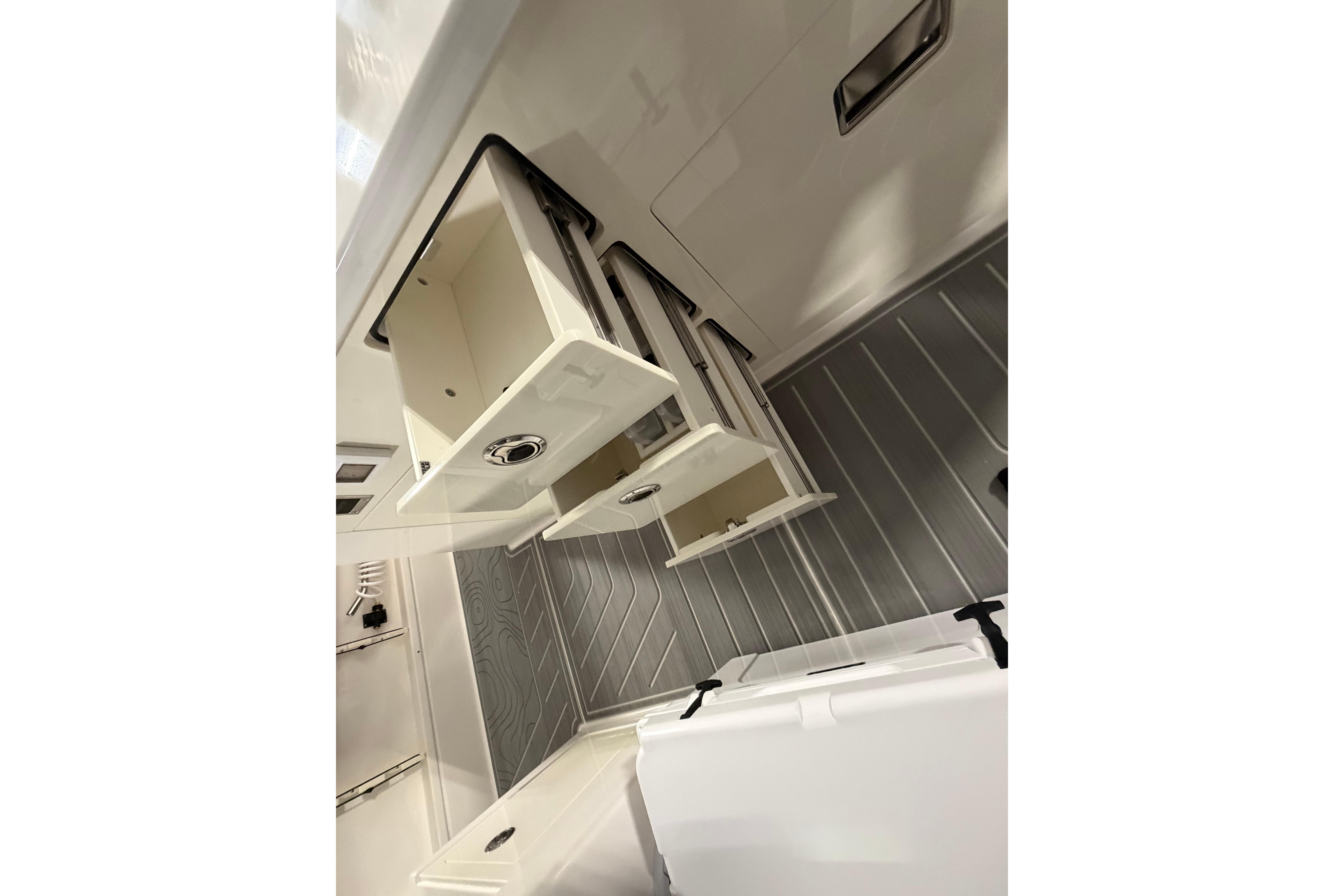 2027 Regal 38 Surf boat interior with open storage compartments and sleek design.