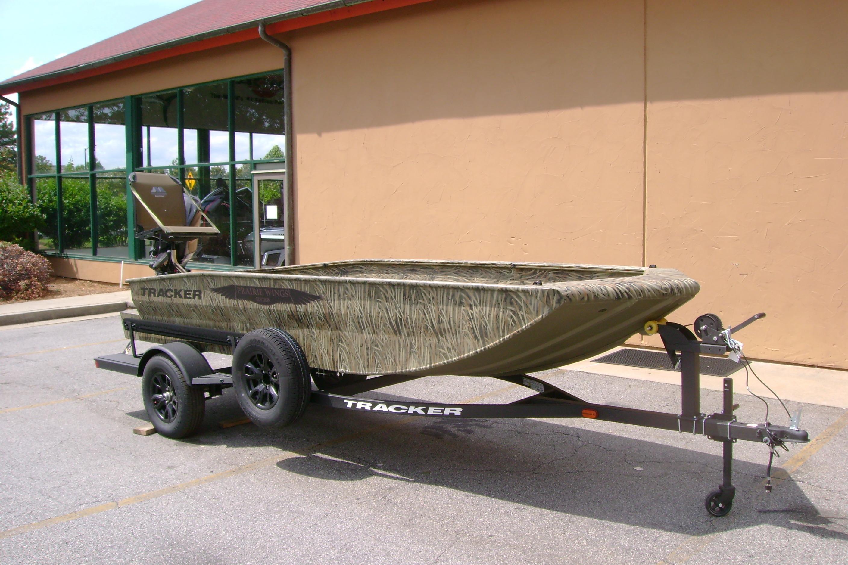 2026 Tracker Grizzly 1650 T Prairie Wings Edition boat on trailer, parked outdoors.