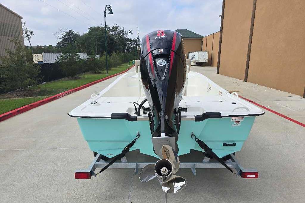 2026 Mako Pro Skiff 19 CC boat on trailer, rear view with outboard motor.