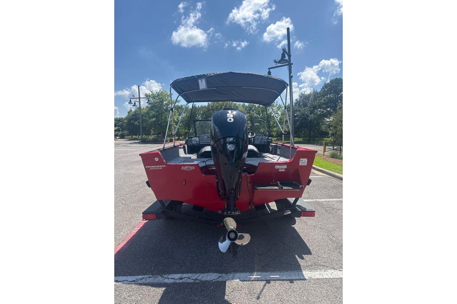 2026 Tracker Pro Guide V-175 Combo boat, red exterior, parked under a clear blue sky.