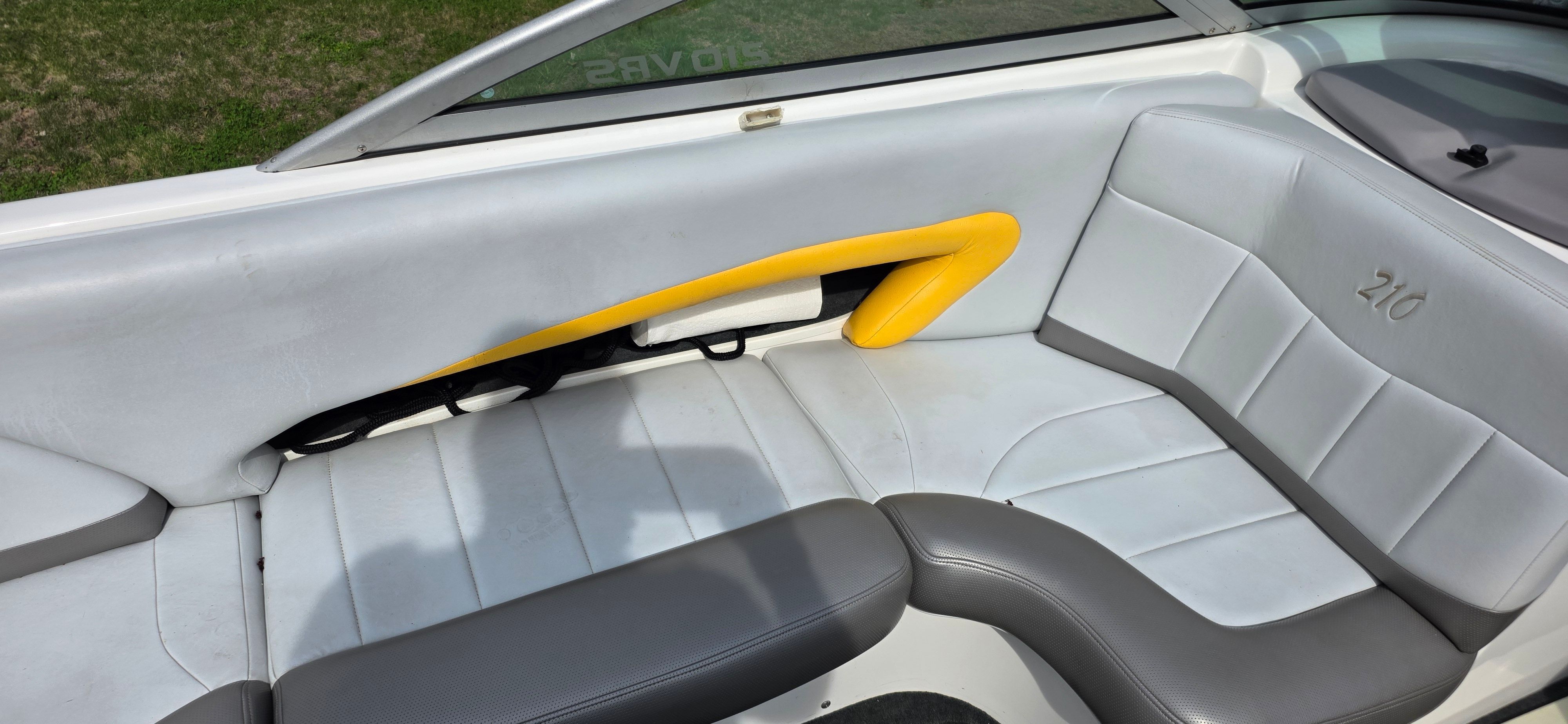 Interior of a 2004 MasterCraft Maristar boat with gray and yellow seating.