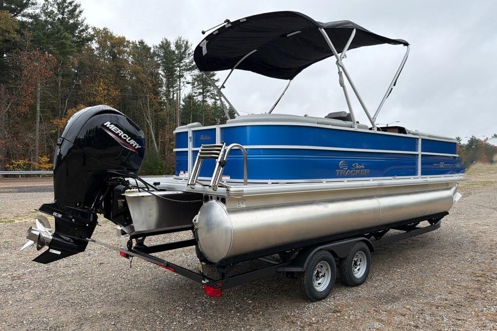 2026 Sun Tracker Party Barge 22 DLX pontoon boat with Mercury engine on trailer.