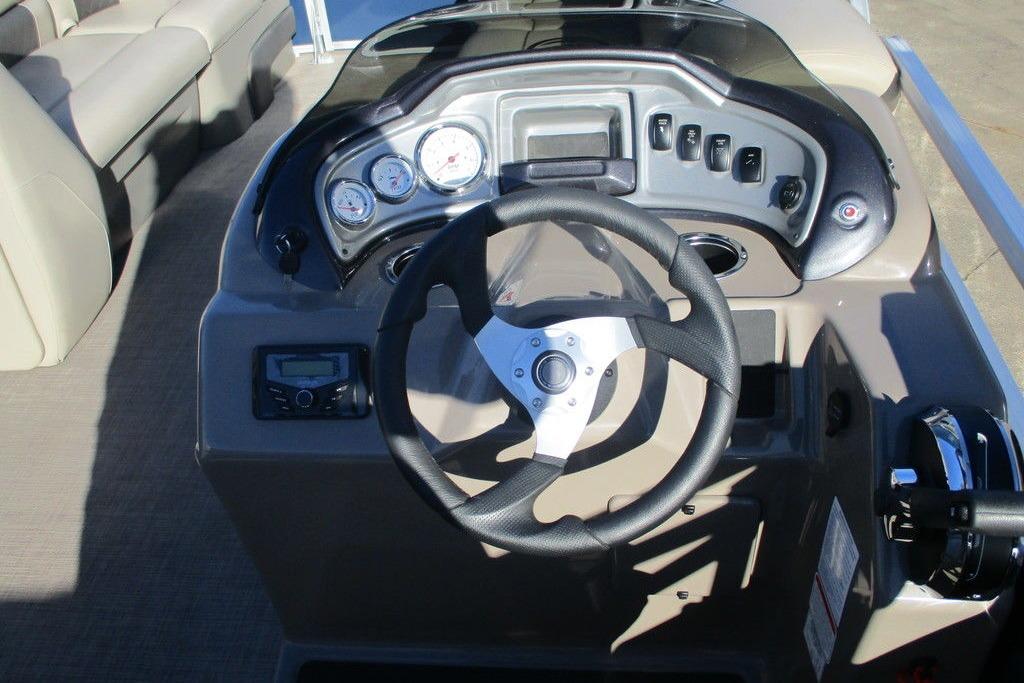 2022 Sun Tracker Party Barge 20 DLX dashboard with steering wheel and control panel.