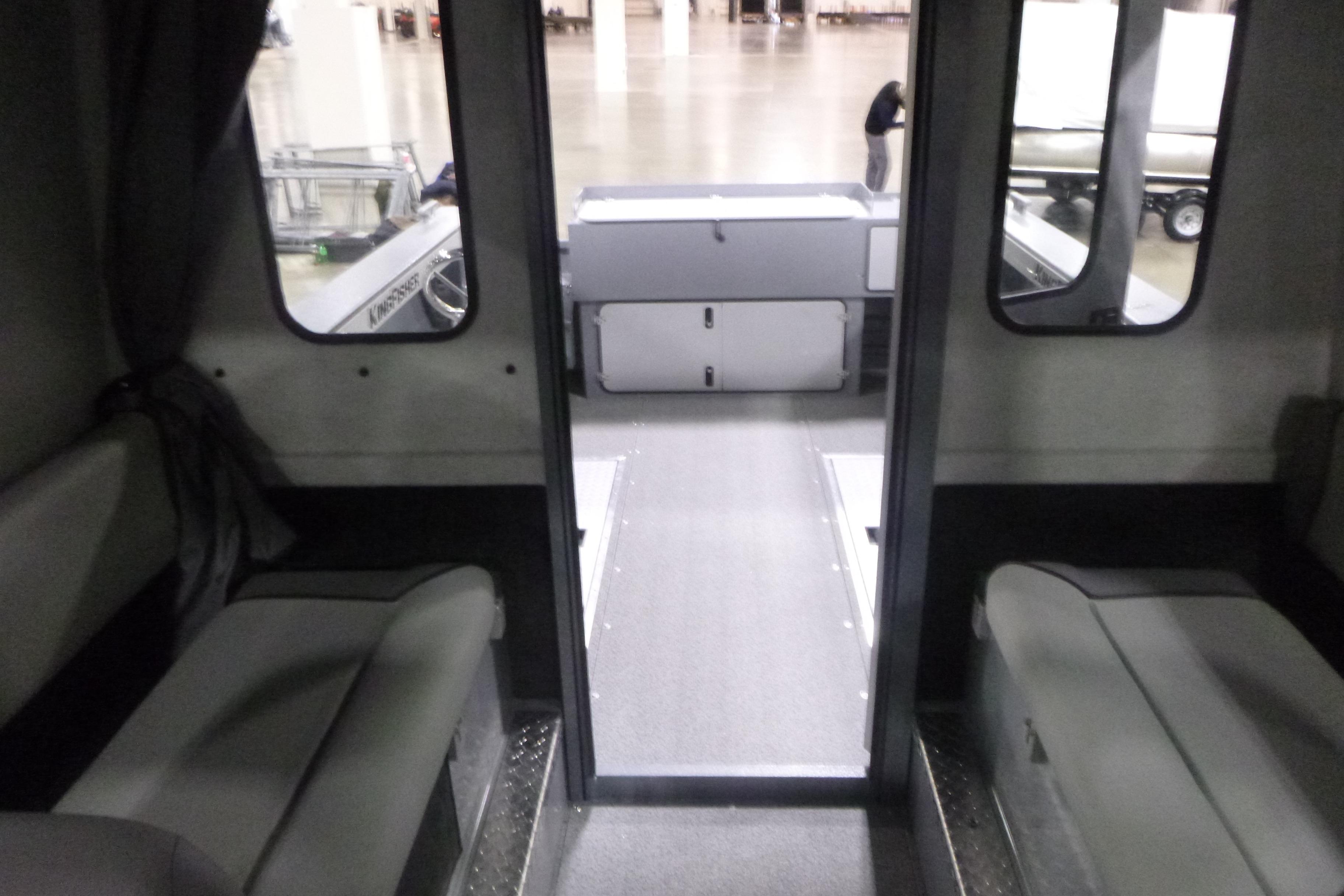 Interior view of 2026 KingFisher 2425 Escape HT boat, showcasing seating and cabin layout.
