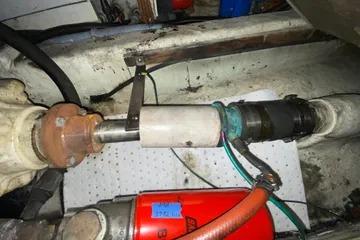 Engine compartment of a 1982 C @ L Sea Ranger boat, showing mechanical components and hoses.