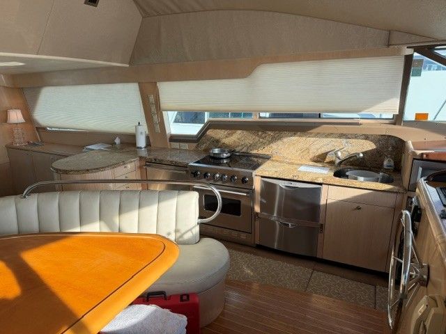 Interior of a 1990 custom motor yacht with kitchen and dining area.