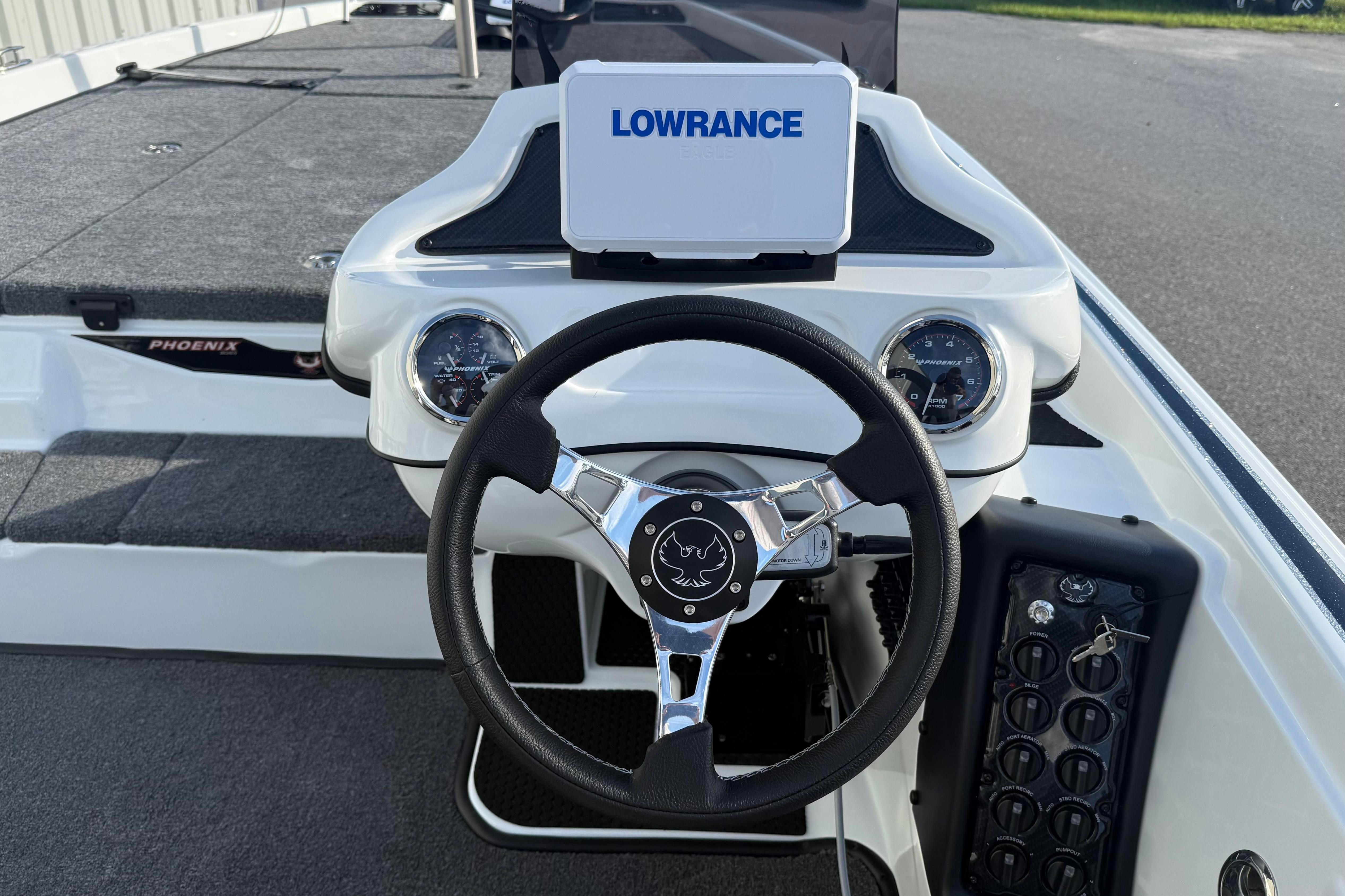 2027 Phoenix 721 ZXL boat dashboard with Lowrance display and steering wheel.