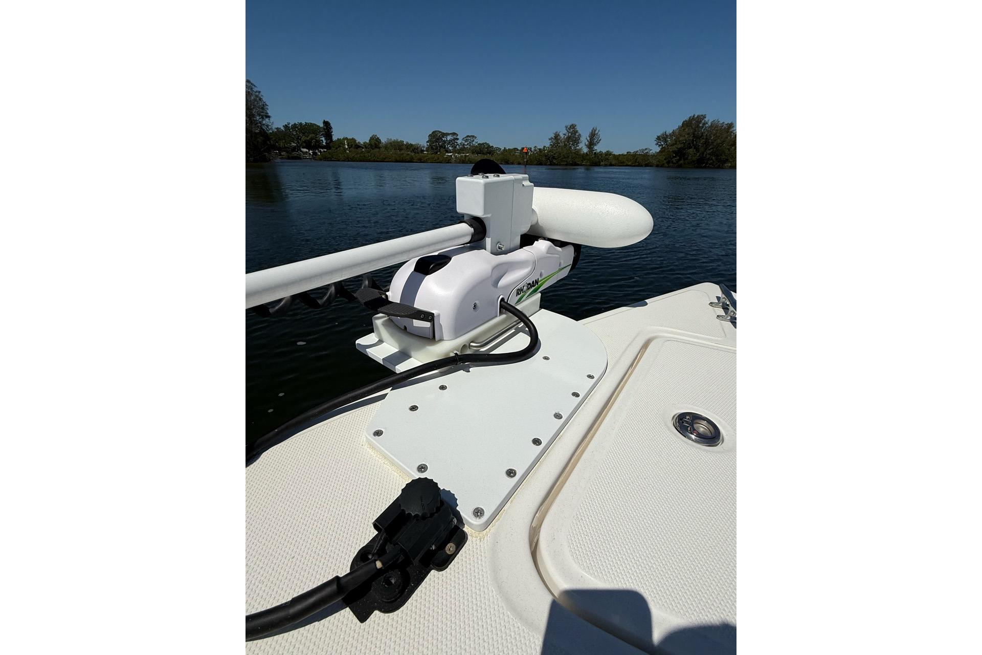 2021 Custom Infusion 34 CC boat with mounted trolling motor on calm water.