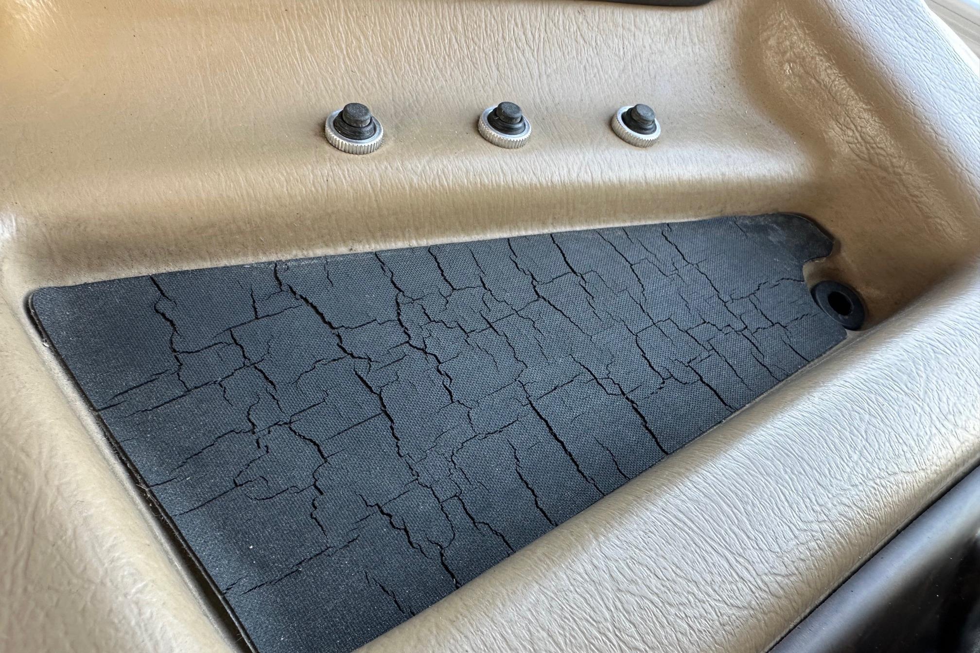 Cracked dashboard panel of 2017 Bennington 22 GPD boat with three control buttons.