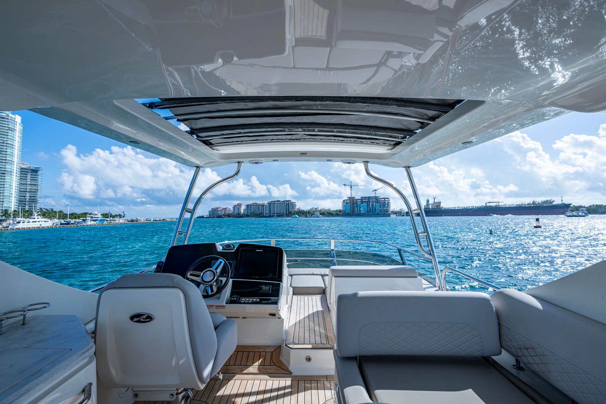 Luxurious 2018 Sea Ray L550 Fly yacht interior with ocean view and modern helm.