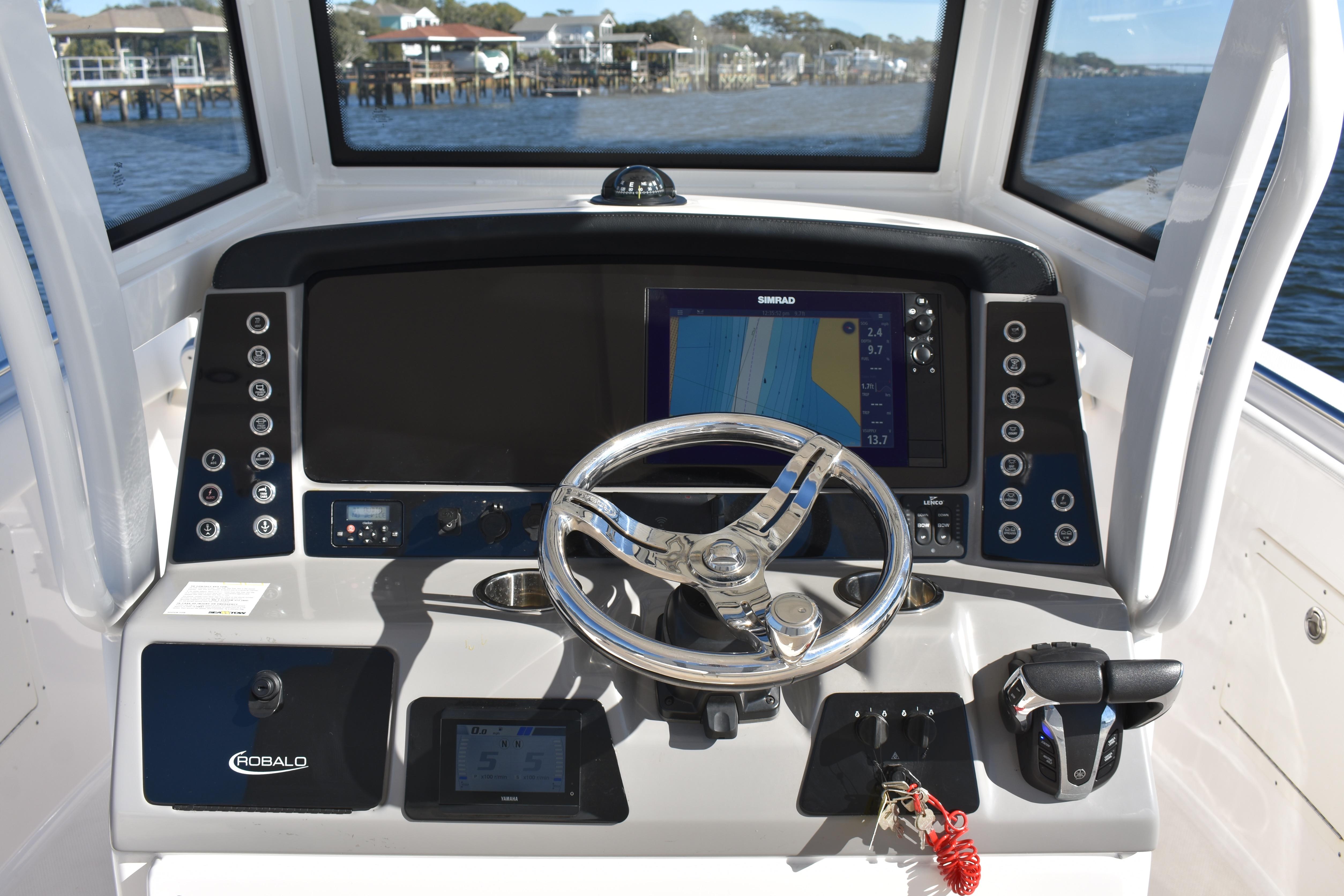 2022 Robalo R272 Center Console boat dashboard with steering wheel and navigation display.