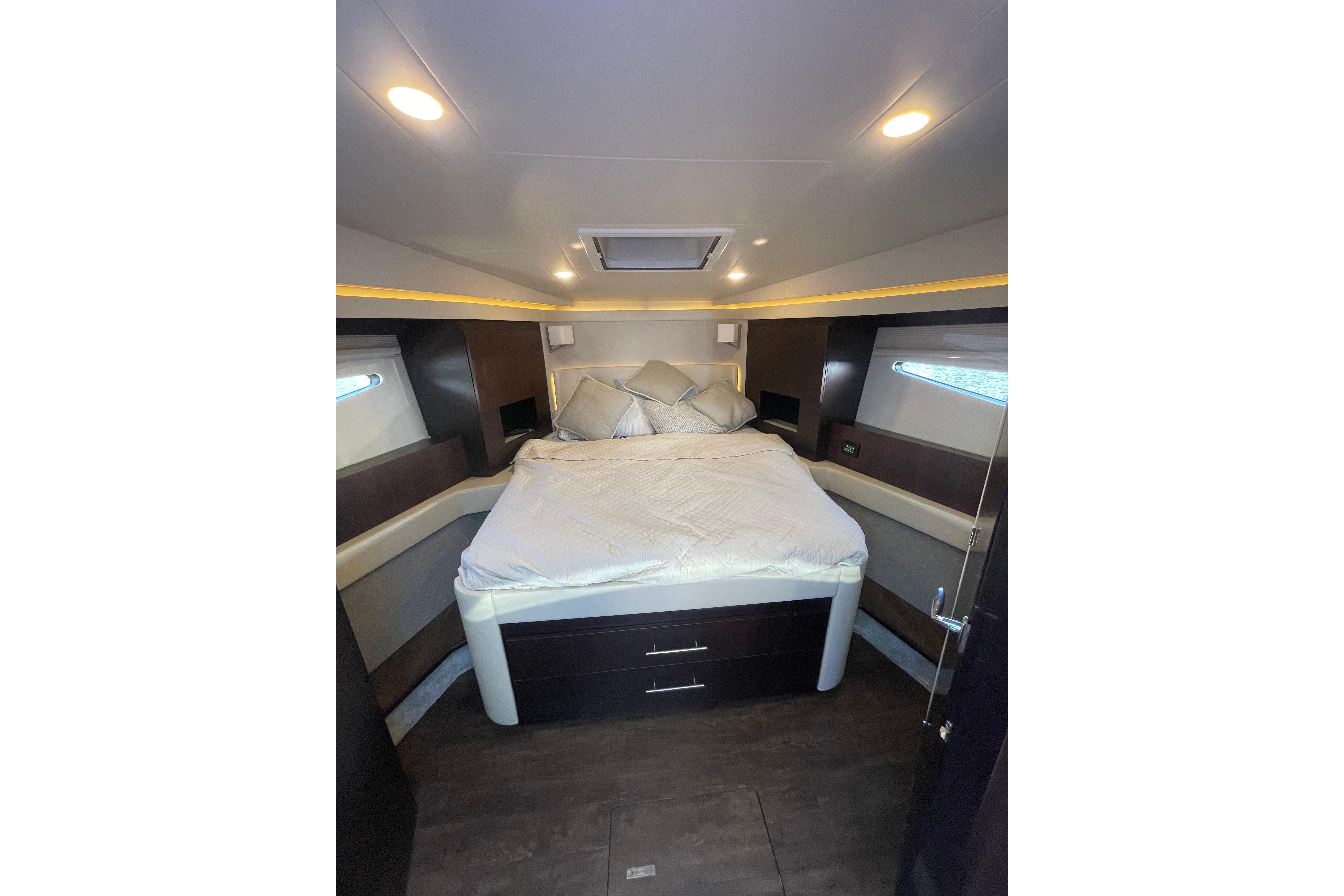Luxurious bedroom interior of 2020 Regal 42 Grande Coupe yacht with modern design.