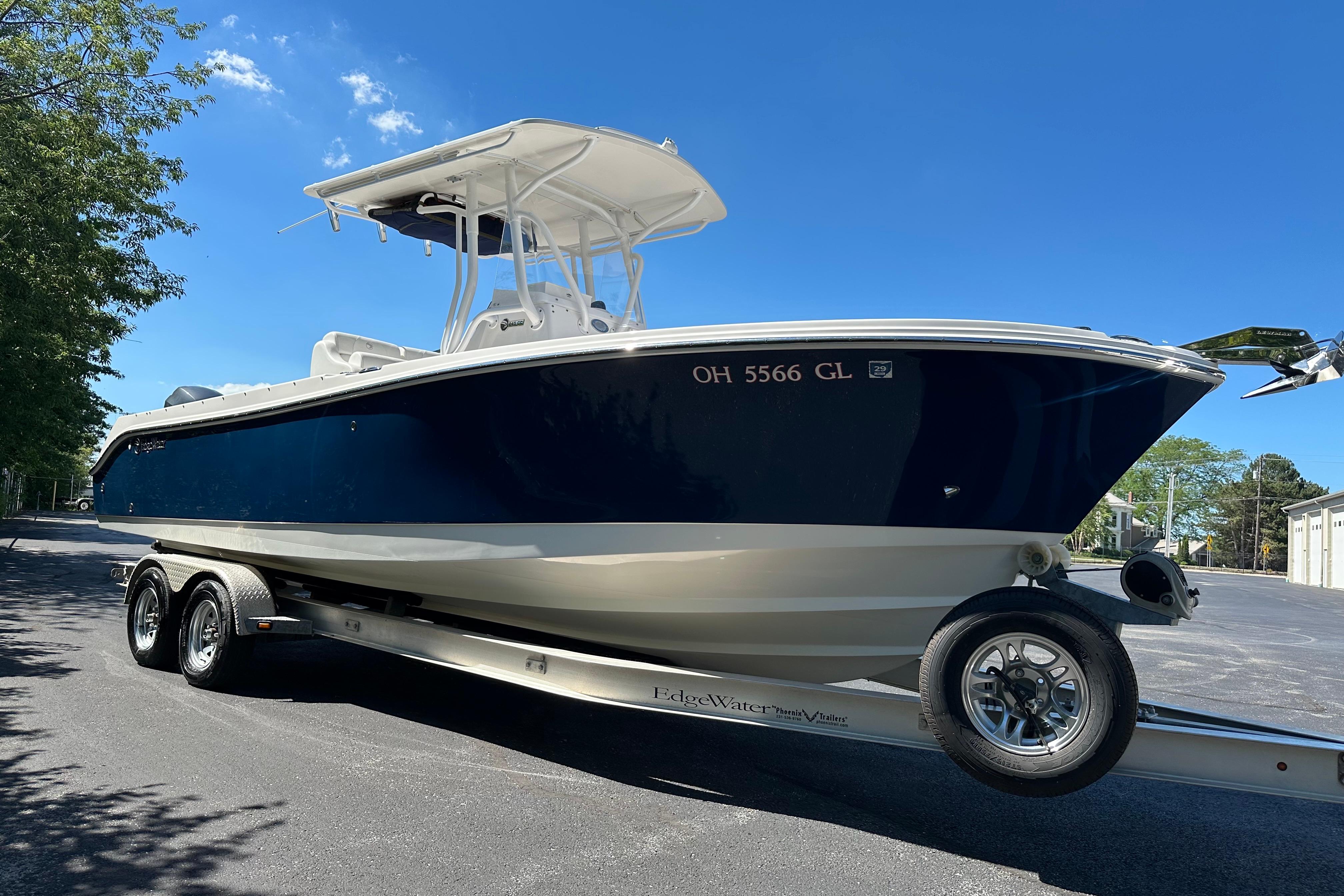 2015 Edgewater 245CC boat on trailer under clear blue sky.
