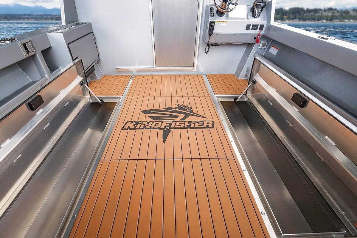 Interior of 2026 KingFisher 3225 GFX Offshore boat with branded flooring and storage compartments.