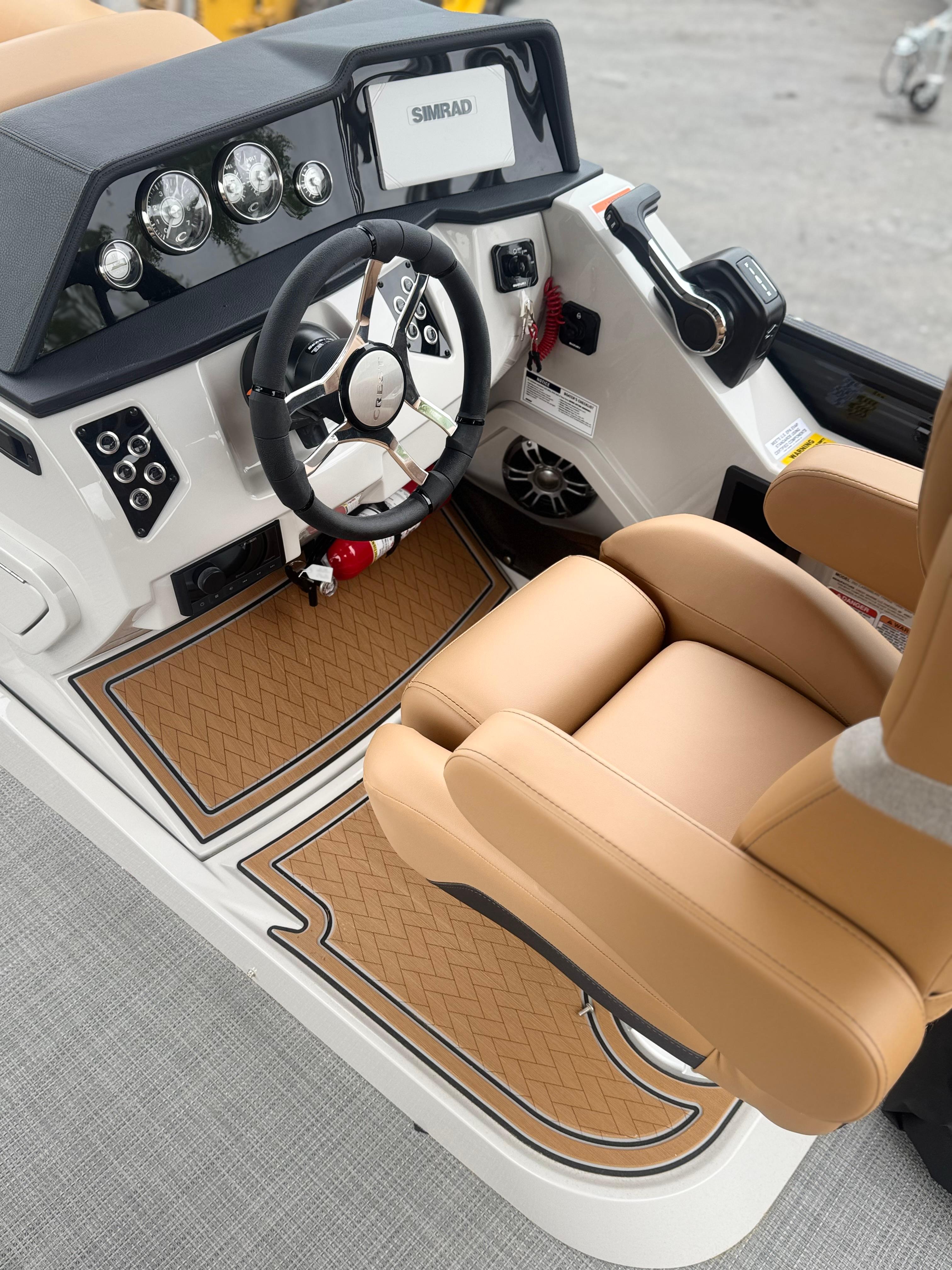 2025 Crest Caribbean LX 250 boat cockpit with tan seating and modern dashboard controls.