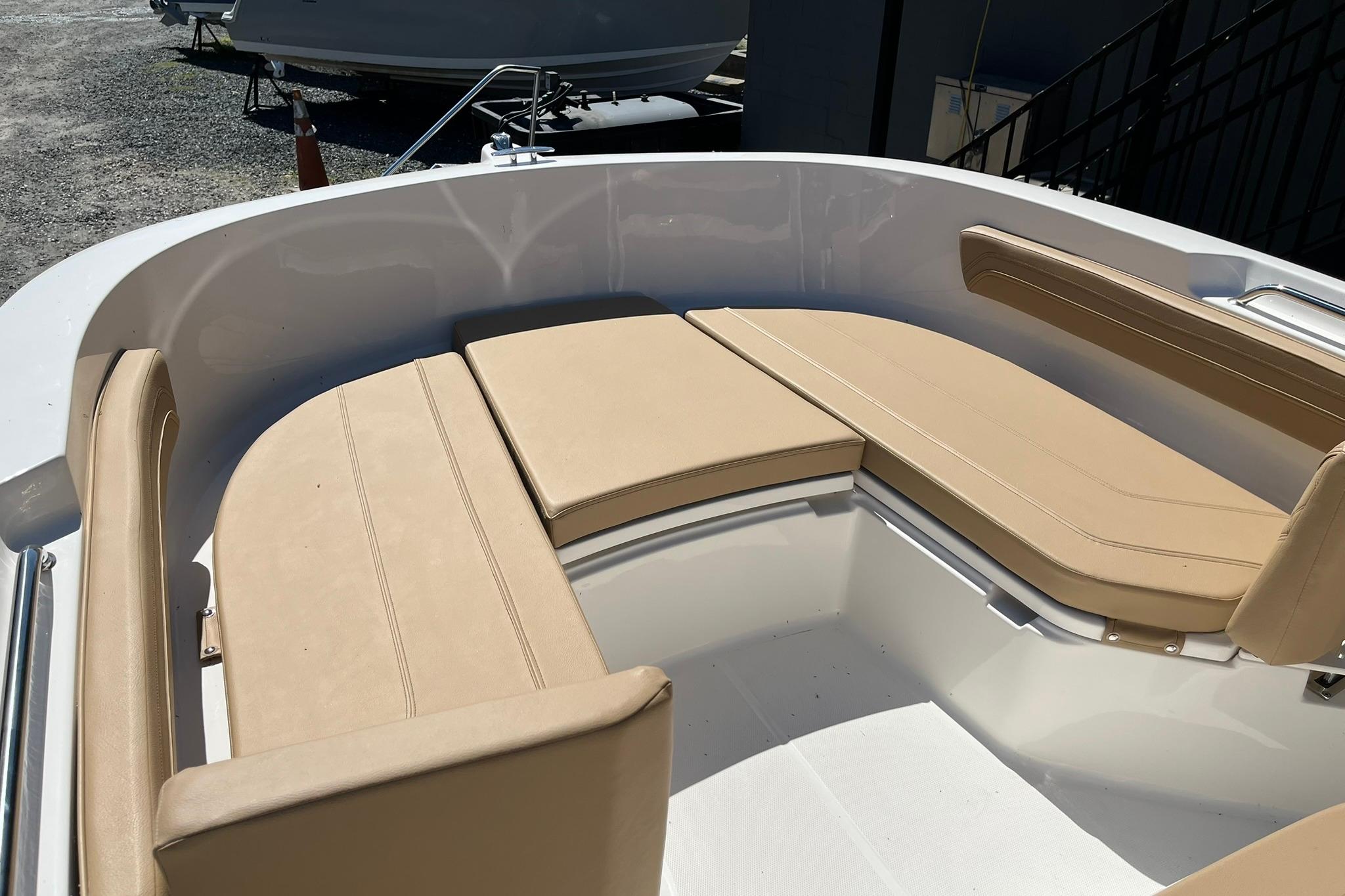 2026 Bayliner Trophy T22CC boat with beige cushioned seating in the bow area.