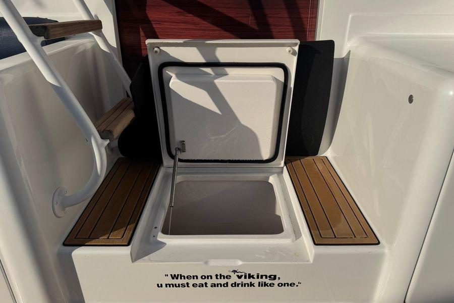 2002 Viking 61 Enclosed Bridge boat with open storage compartment and humorous quote.