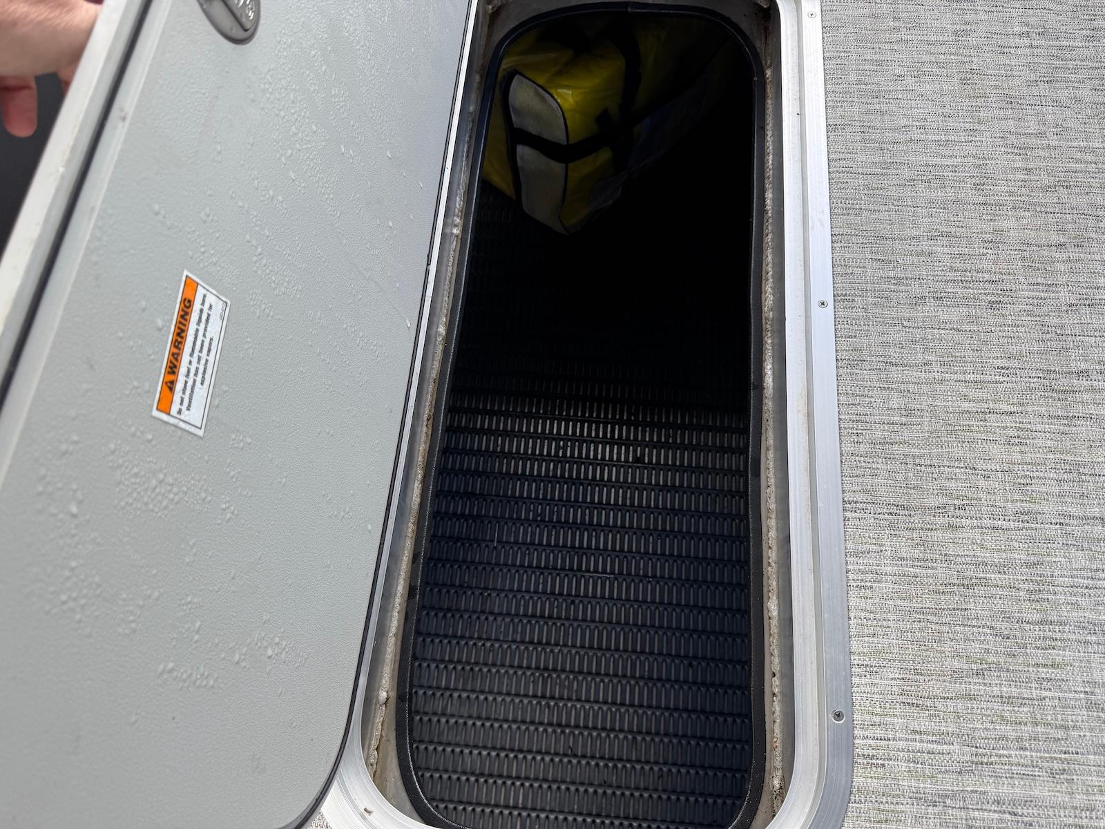 Open storage compartment on 2023 Godfrey Monaco 255 SD boat.