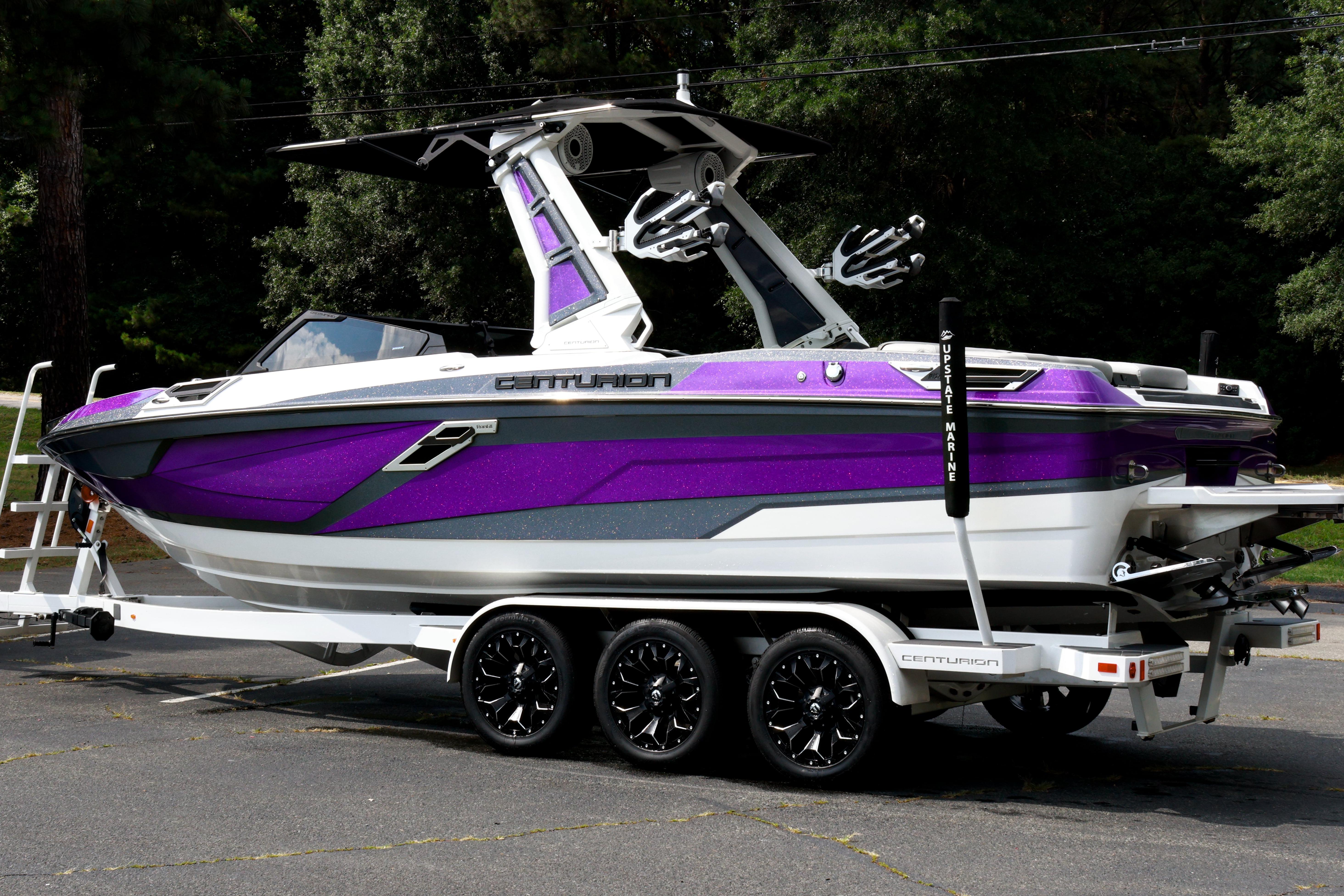 2022 Centurion Ri245 boat with purple and white design on a trailer.
