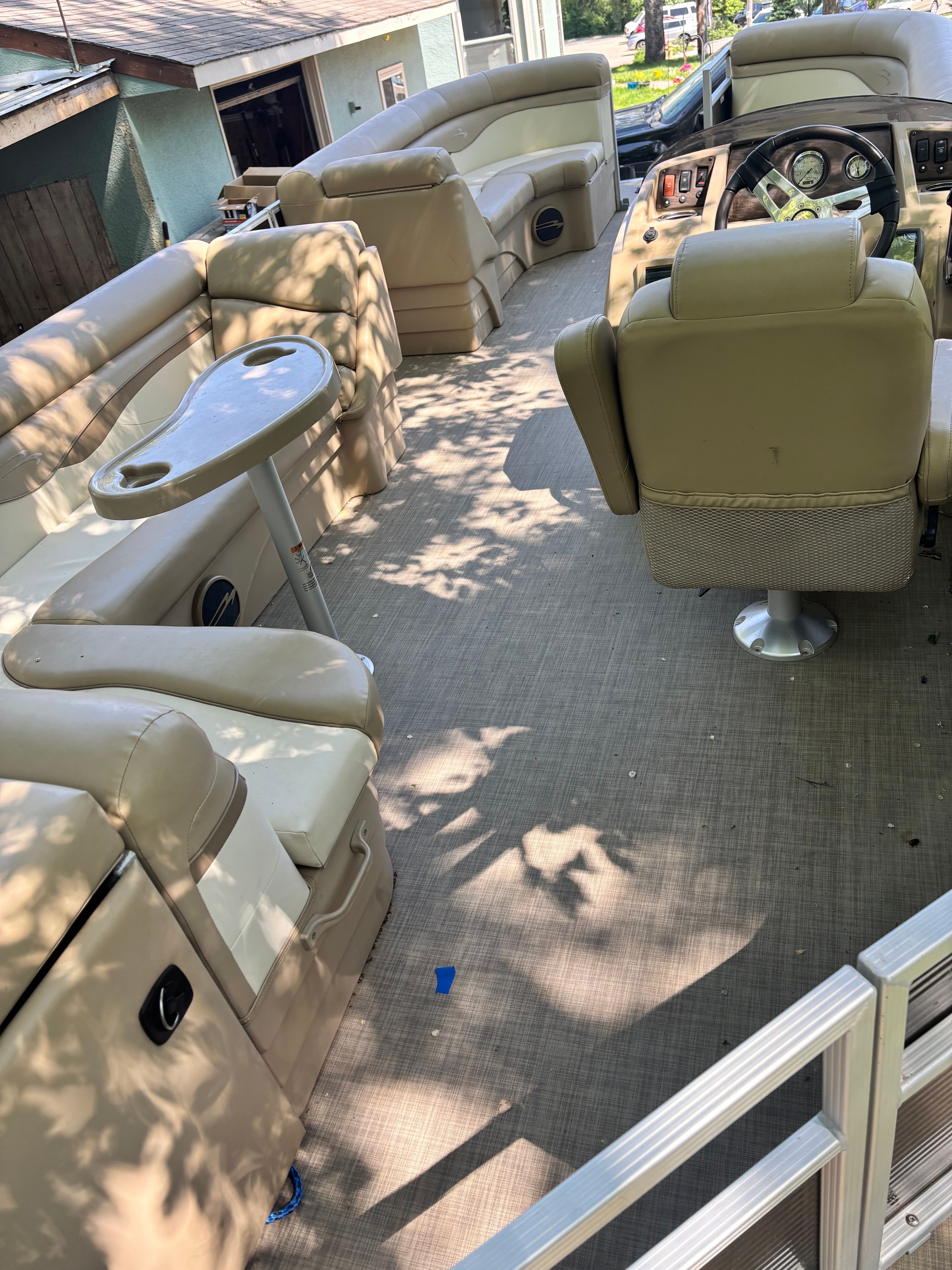 Interior of a 2016 Bennington 22 SLX pontoon boat with beige seating.