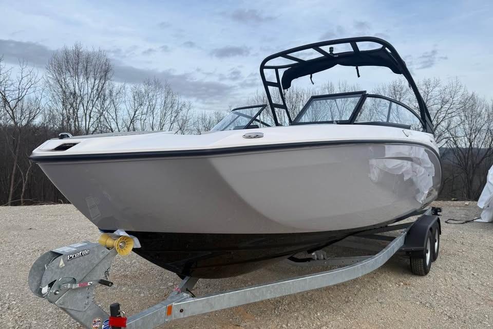 2026 Yamaha Boats AR250 on trailer, parked outdoors with trees in background.