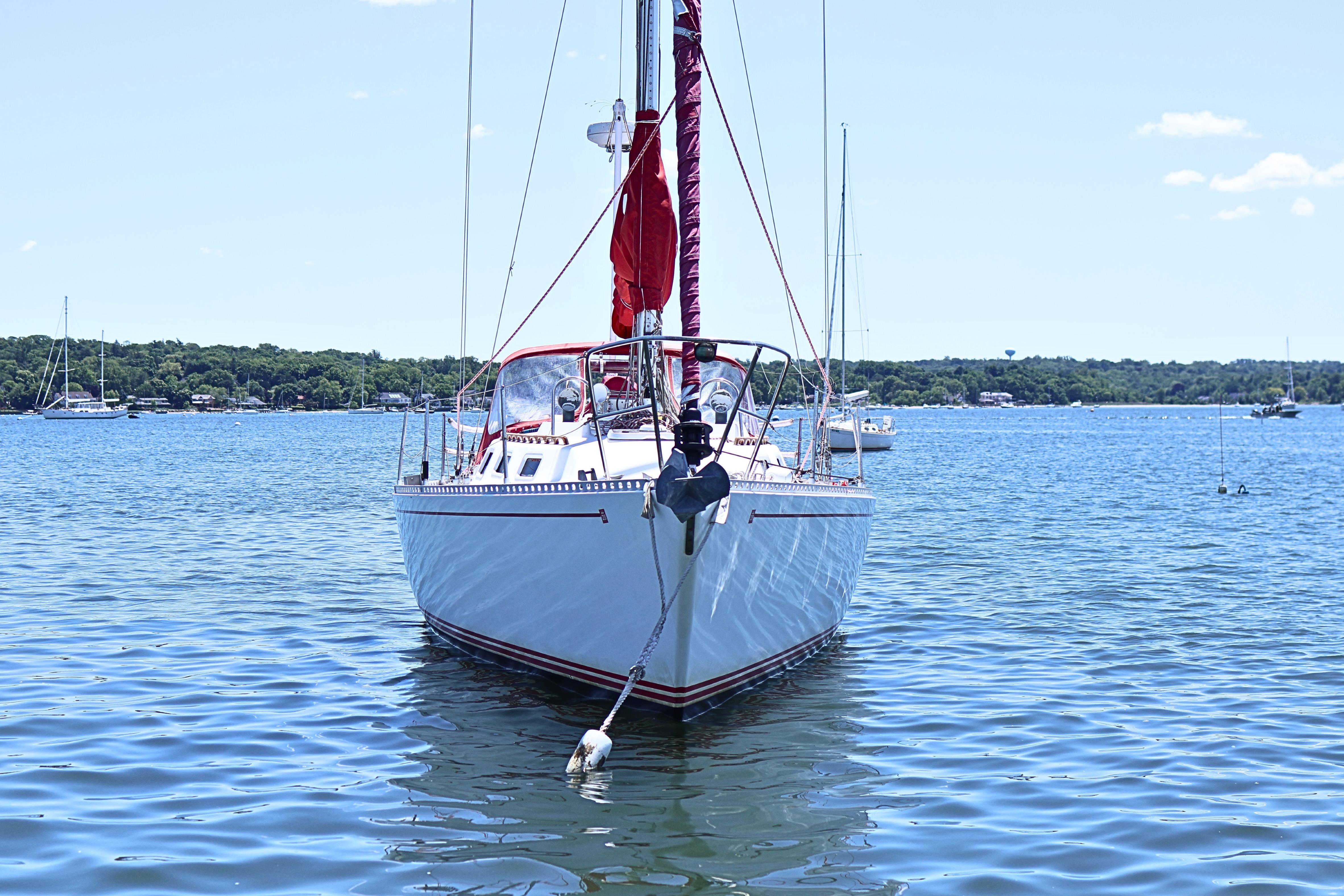 1989 J Boat J 40 sailboat anchored on calm blue water.