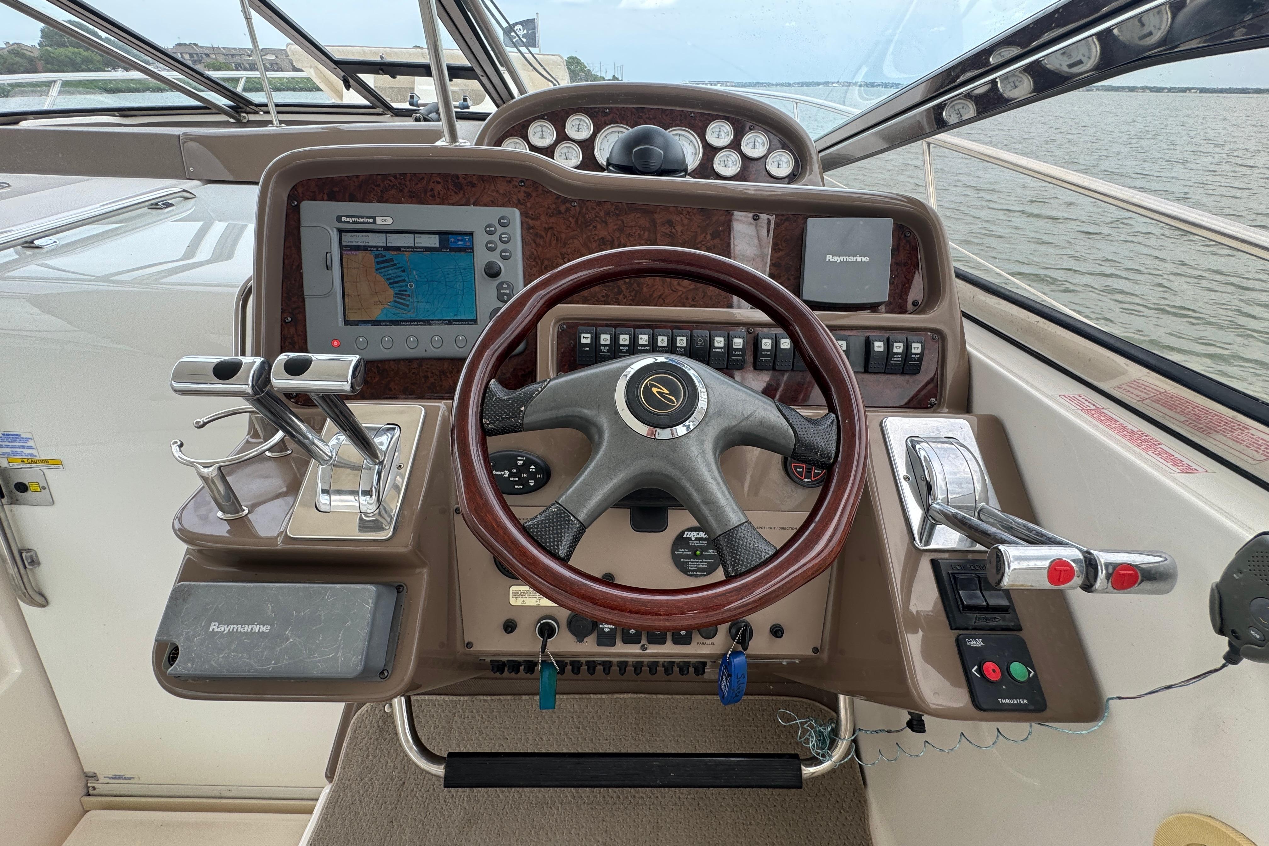 Cockpit of 2005 Regal Commodore 4260 boat with steering wheel and navigation controls.