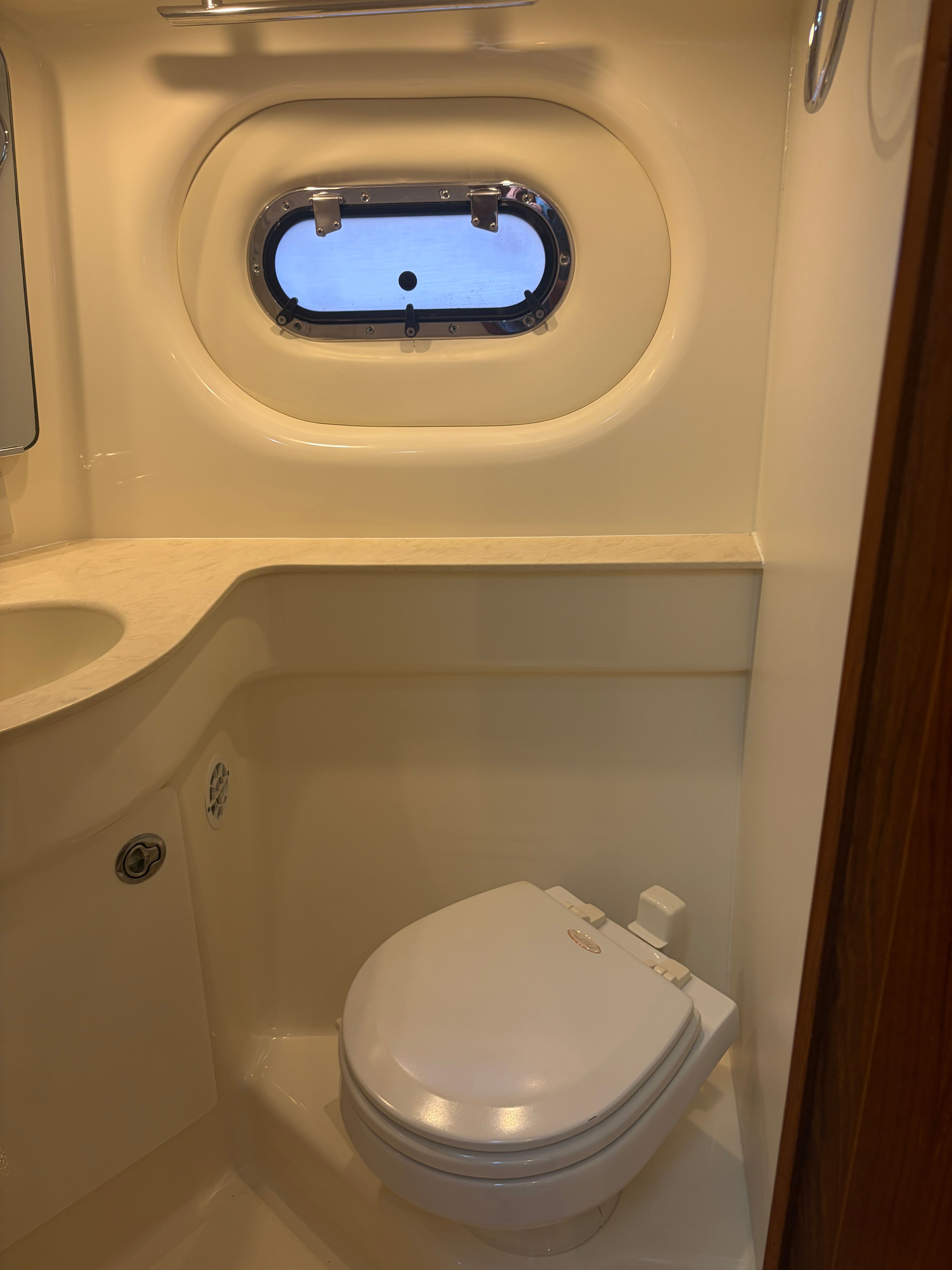 Interior of 2005 Tiara Yachts Sovran with toilet and porthole.