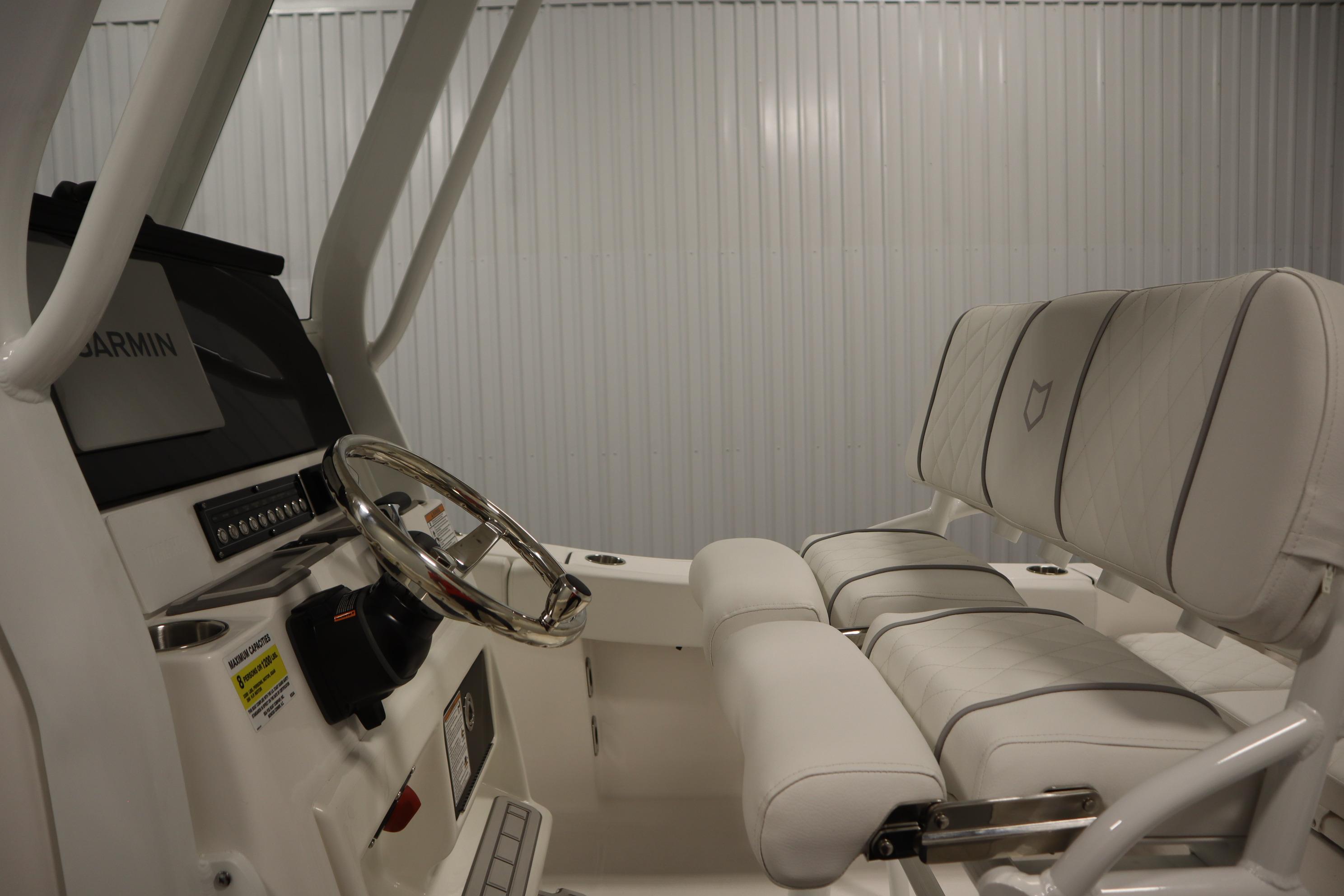 2026 Sea Fox 228 Commander boat interior with steering wheel and cushioned seating.