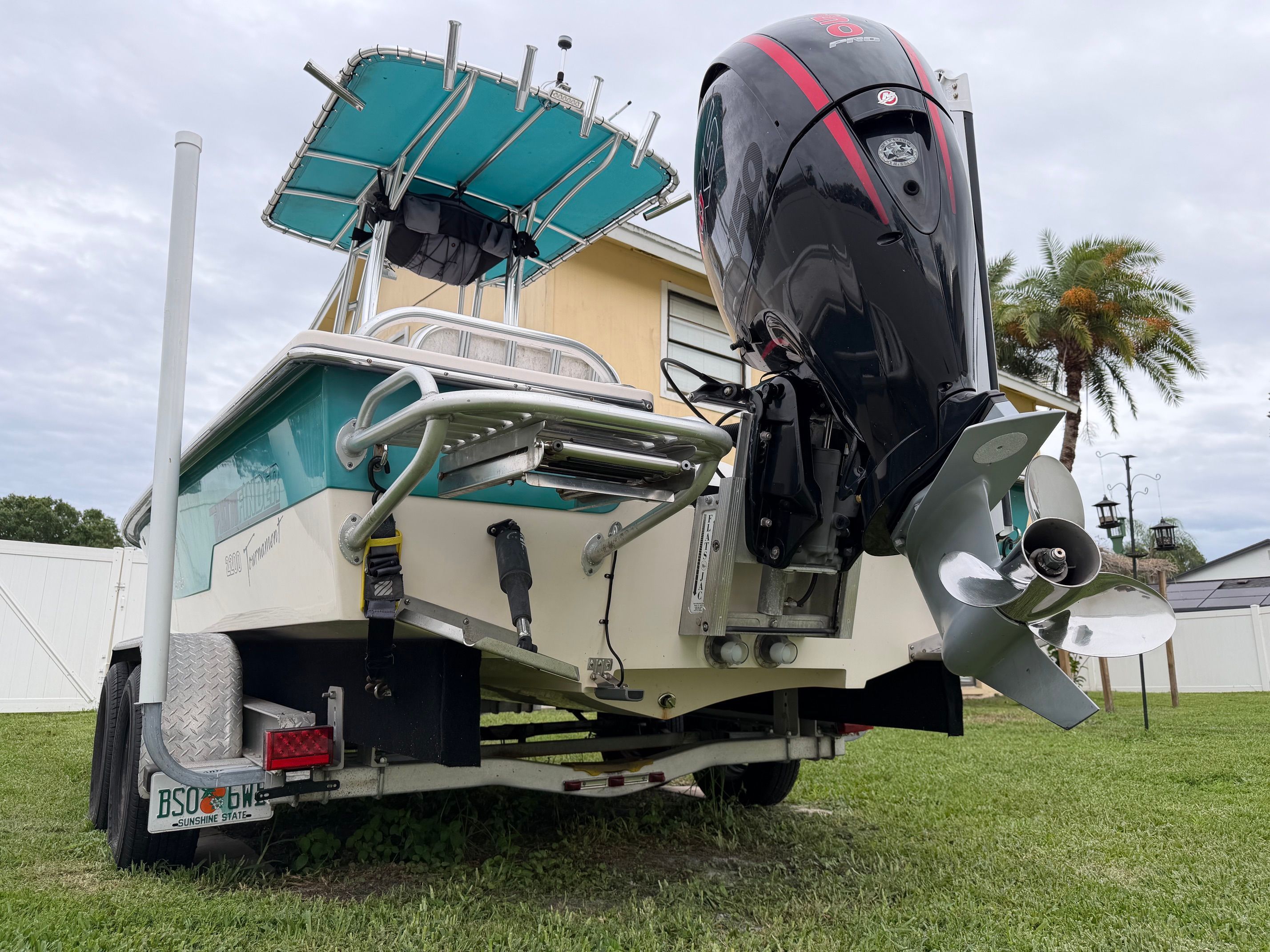 A 2006 Pathfinder 2200 Tournament Edition boat on a trailer, parked on grass.