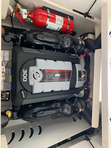 Engine compartment of 2025 Sea Ray SPX 230 with 6.2L 300 HP engine and fire extinguisher.