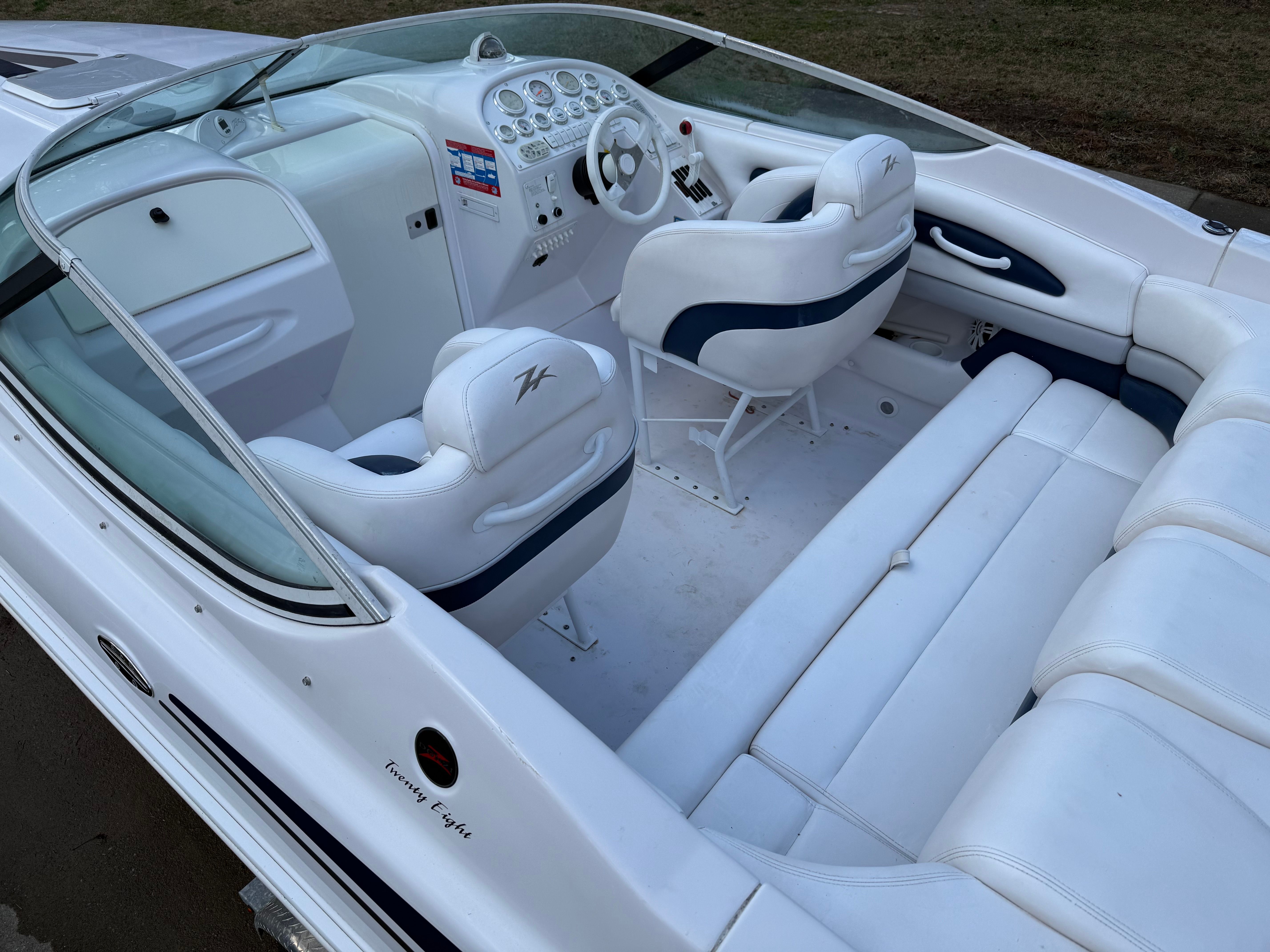 Interior of a 2003 Donzi 28 ZX with white seating and dashboard.
