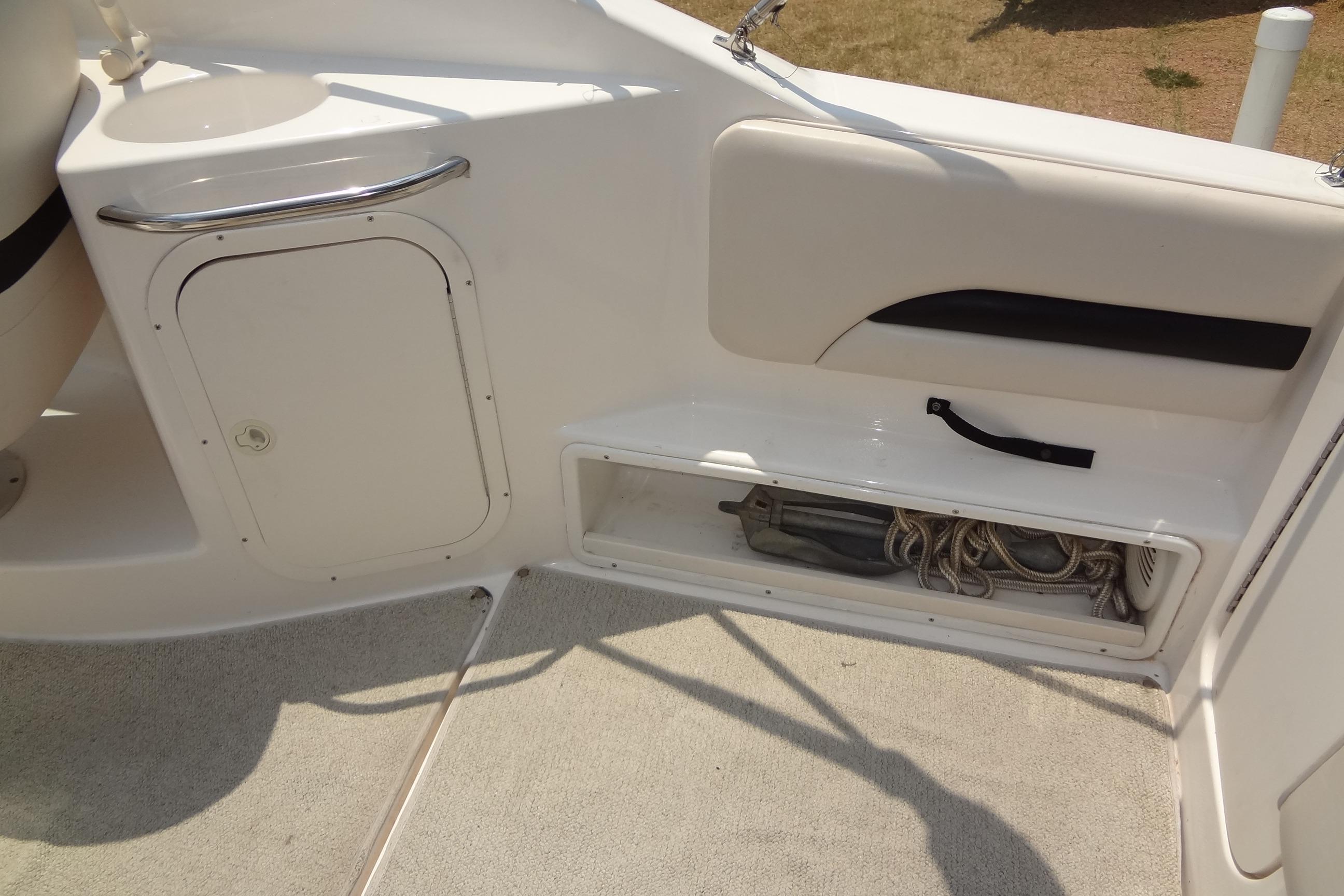 2000 Chaparral Signature 260 boat interior with storage compartment and clean white finish.