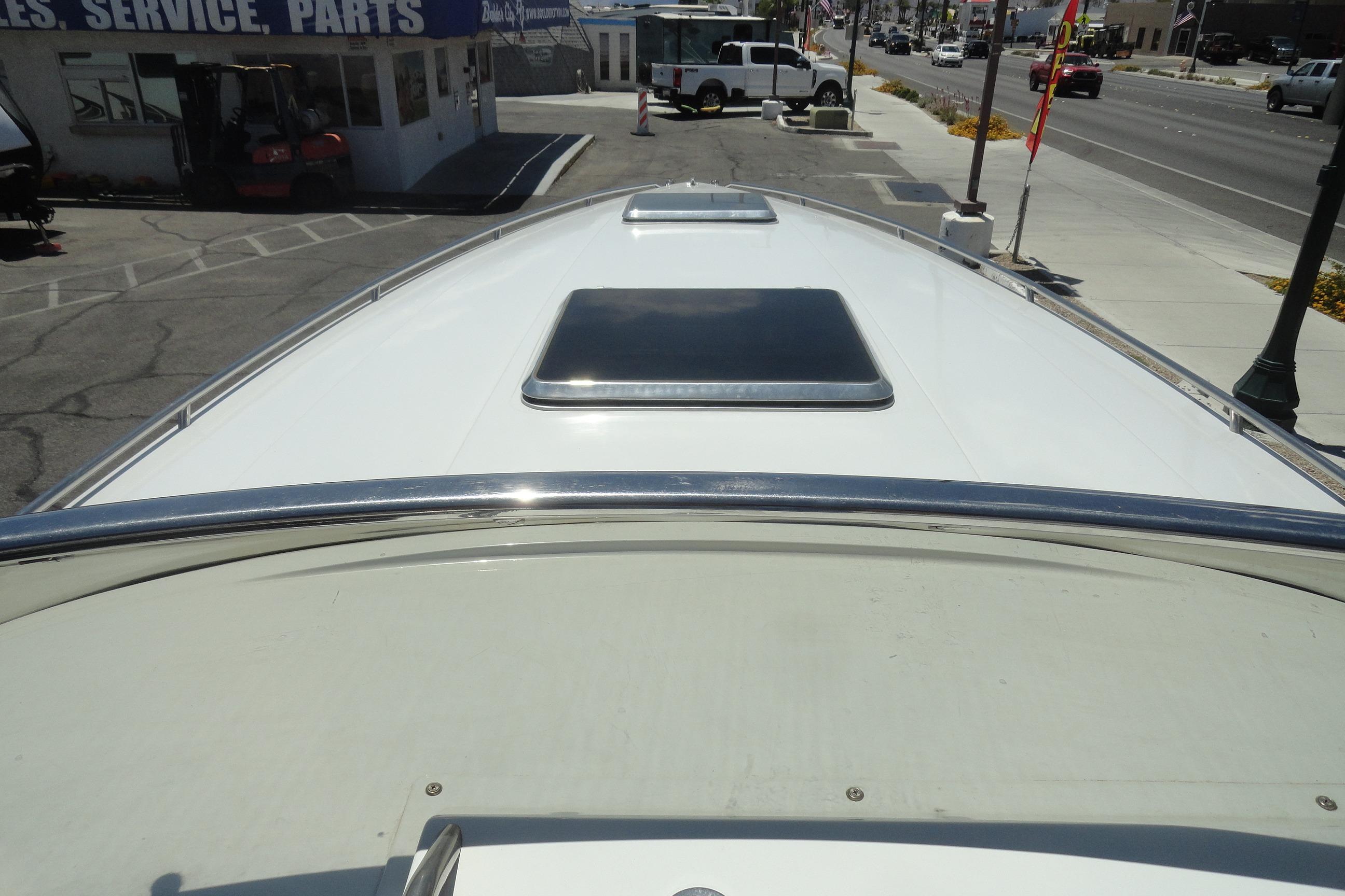 1988 Wellcraft 34 Scarab boat deck view at a marina with service area.