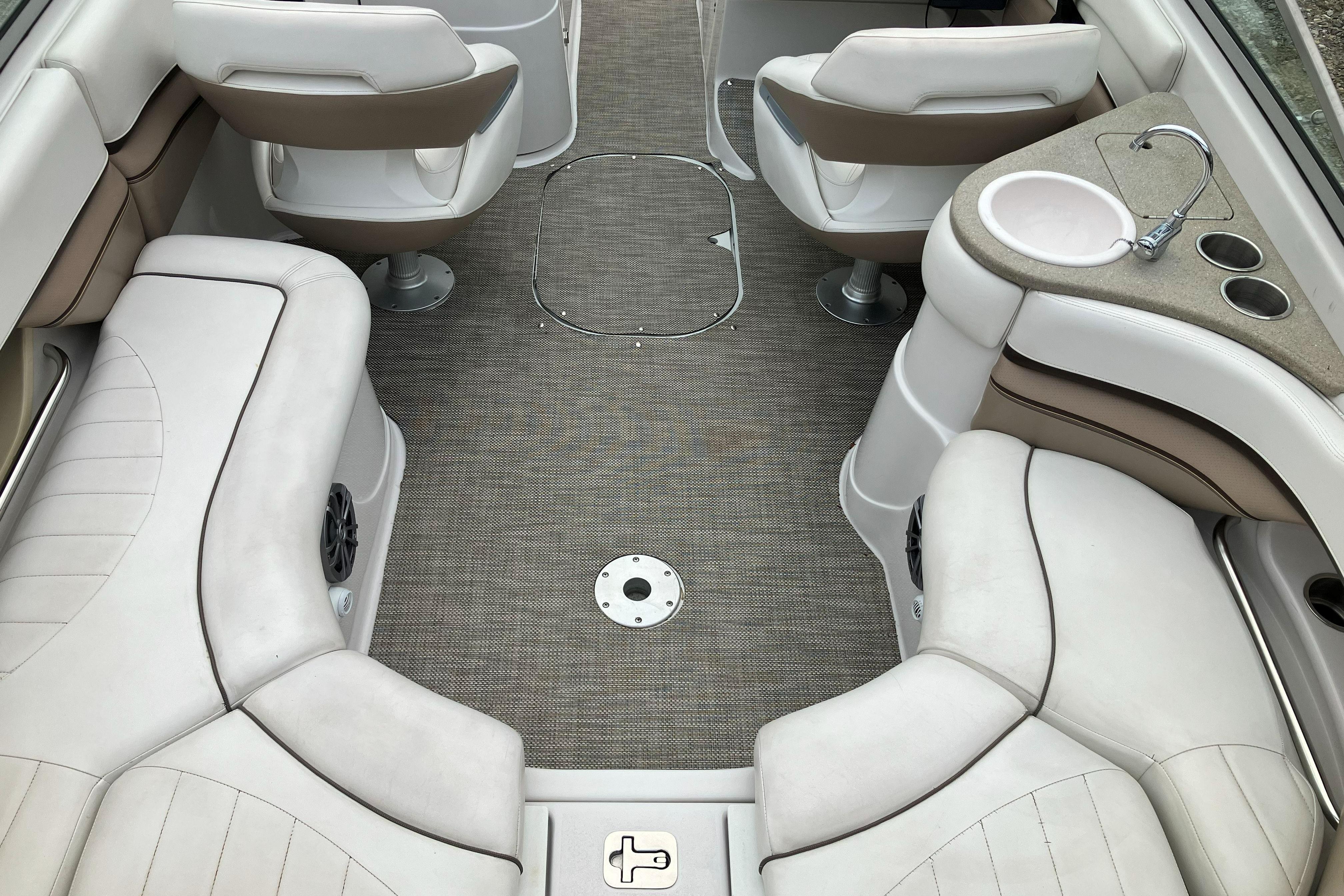 2006 Four Winns 240 Horizon boat interior with seating and sink.