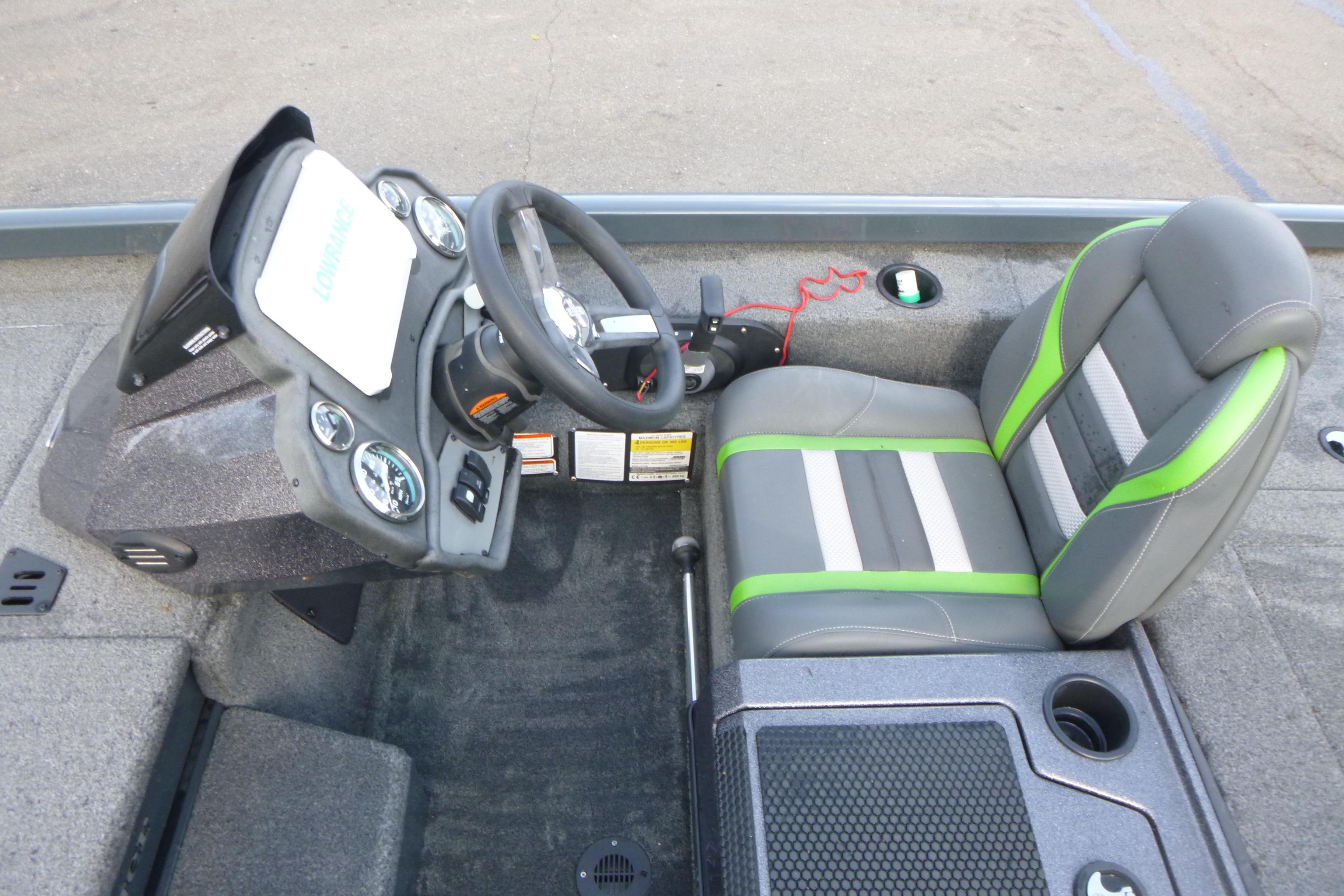 2023 Ranger RT198P boat cockpit with steering wheel, gauges, and green-accented seat.